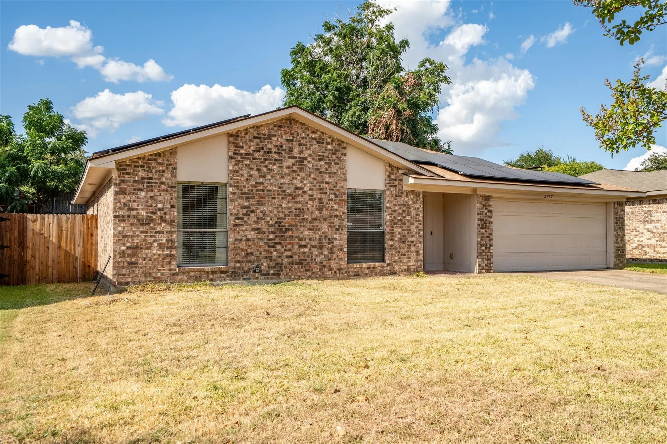 Brick exterior with a gabled roof and attached garage