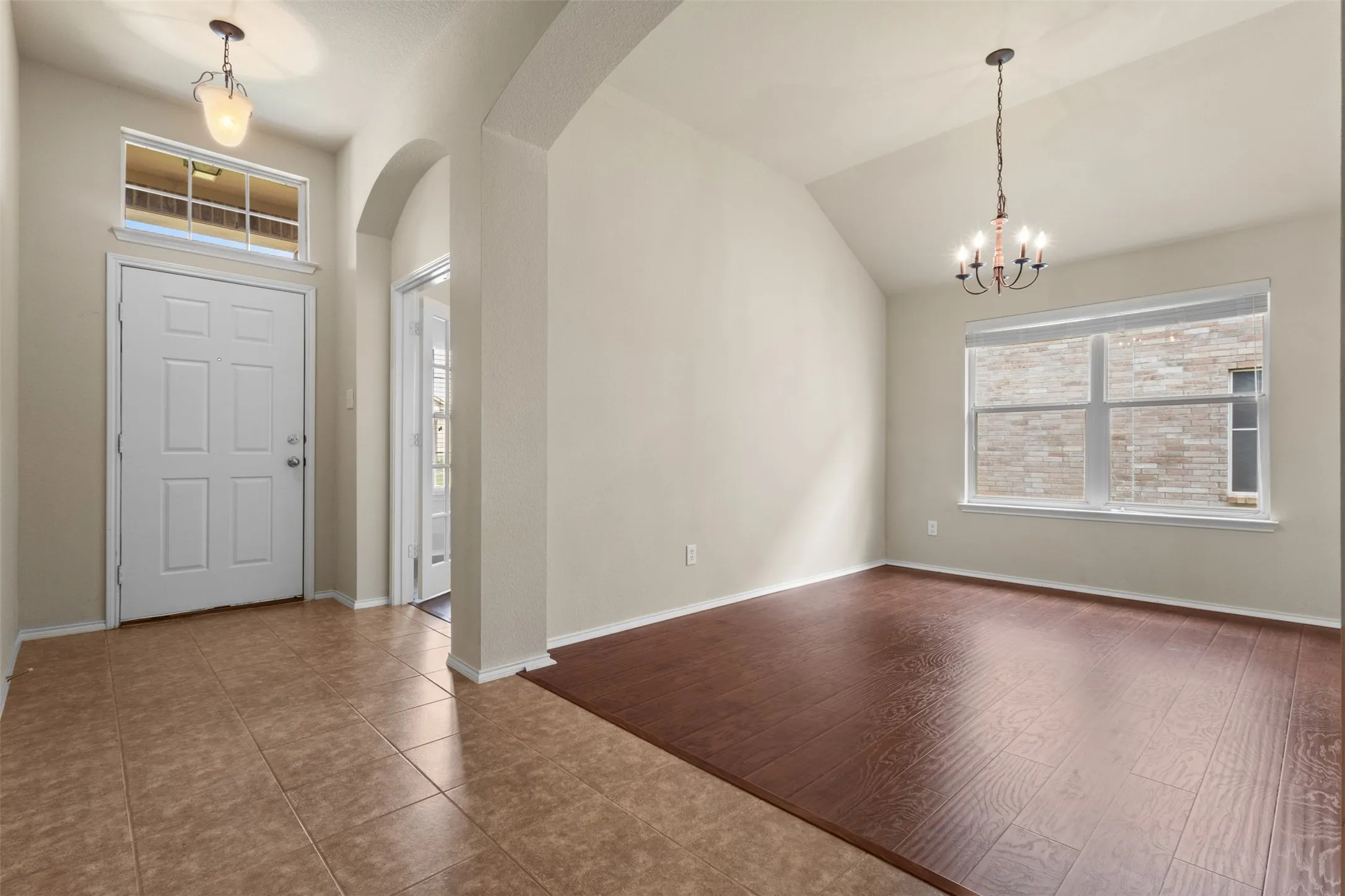 Entryway featuring tile flooring, a transom window, and an overhead light fixture