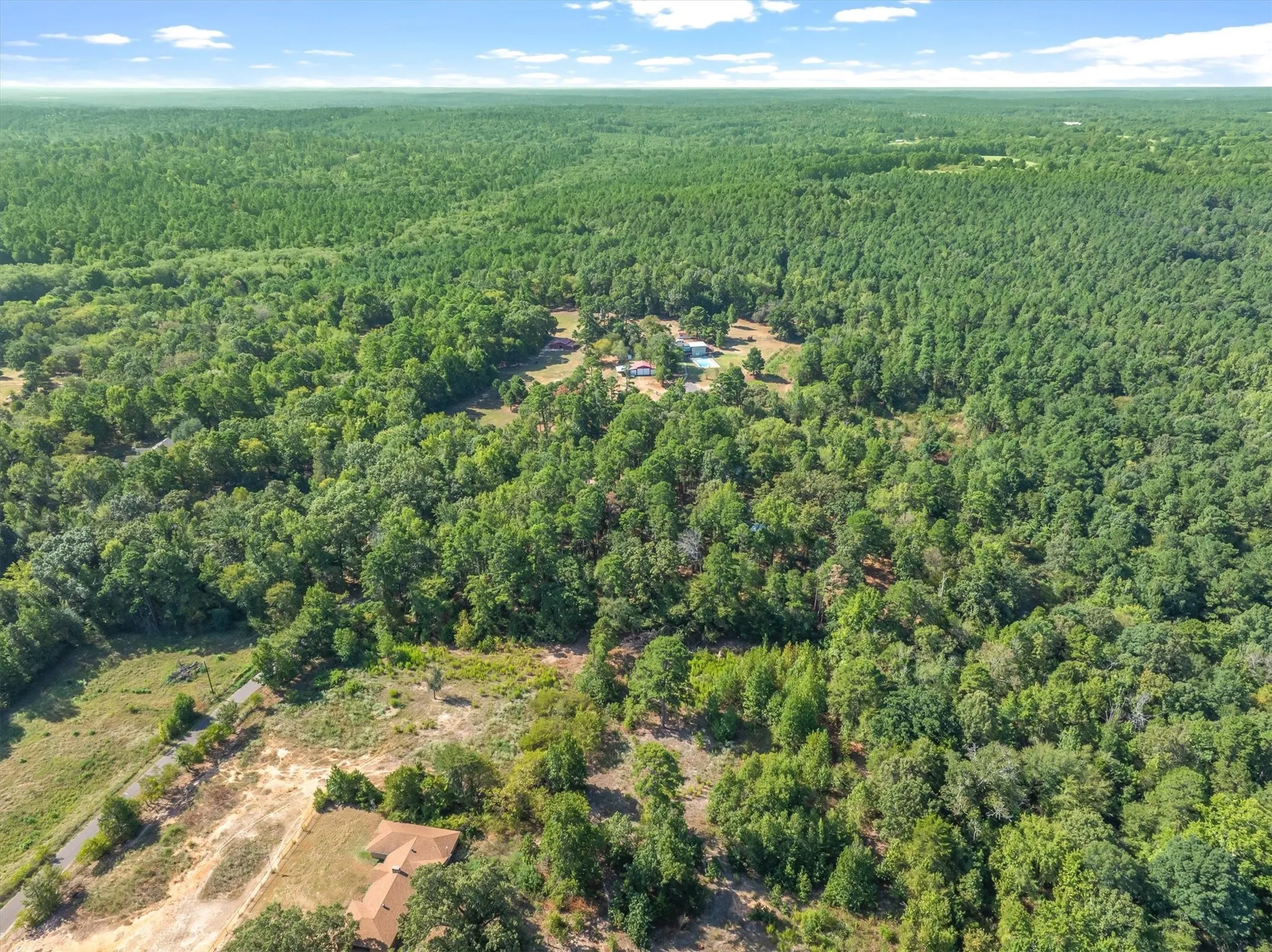 Expansive wooded landscape with scattered clearings