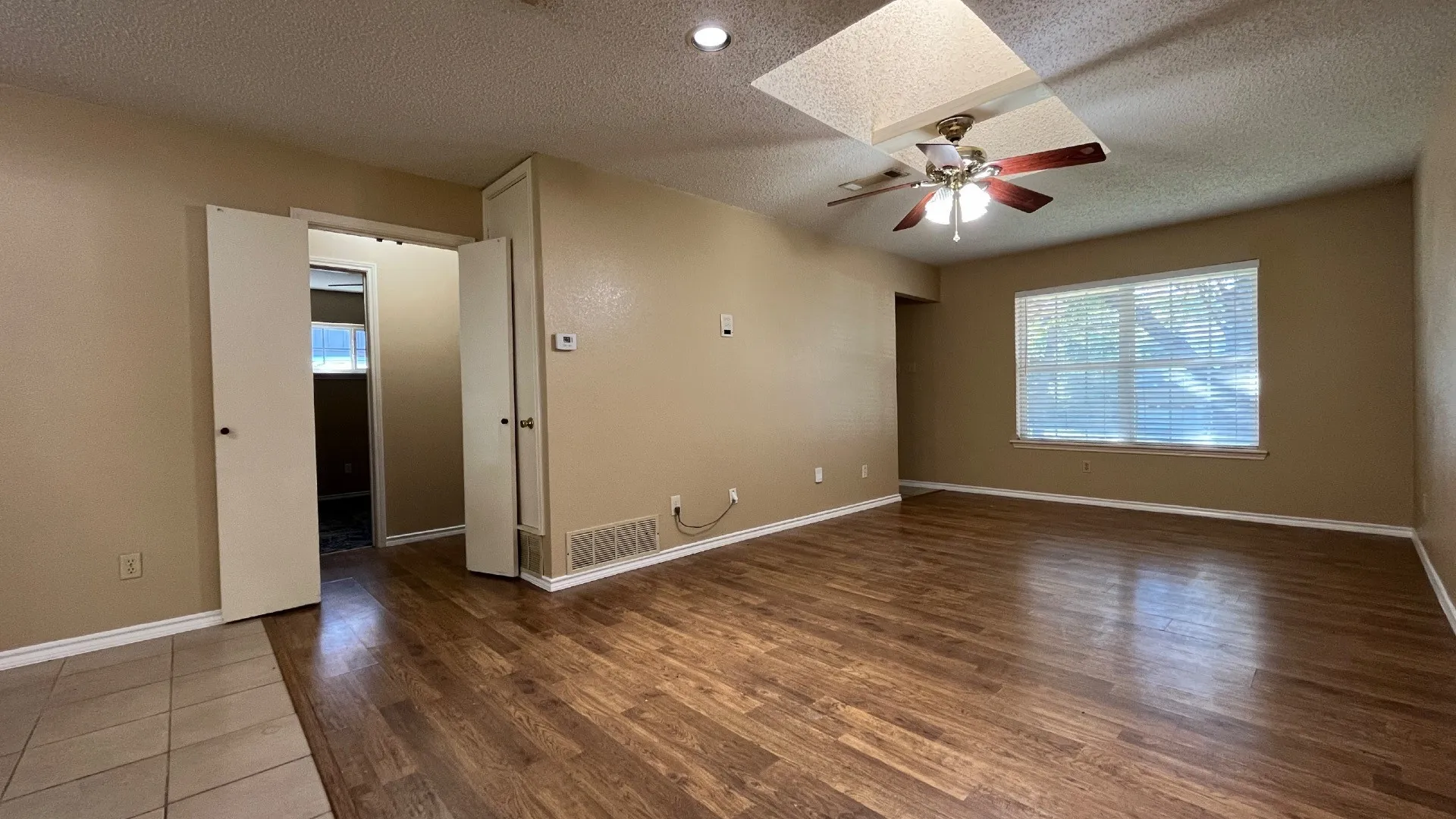 Wood-finish flooring throughout, complemented by a ceiling fan
