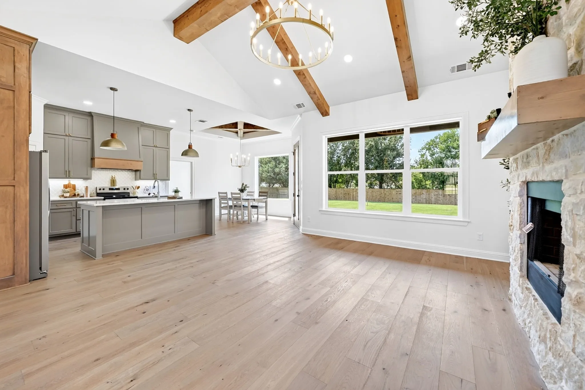 Welcome to 302 Grace Lane, Athens Tx featuring engineered hardwood floors throughout, a soaring stone woodburning fireplace & 16' ceilings in the living area to give the home a welcoming but cozy feel.