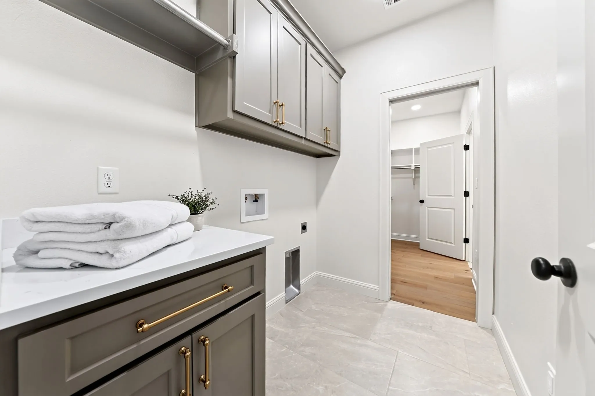 Laundry room flows seamlessly from the primary closet.