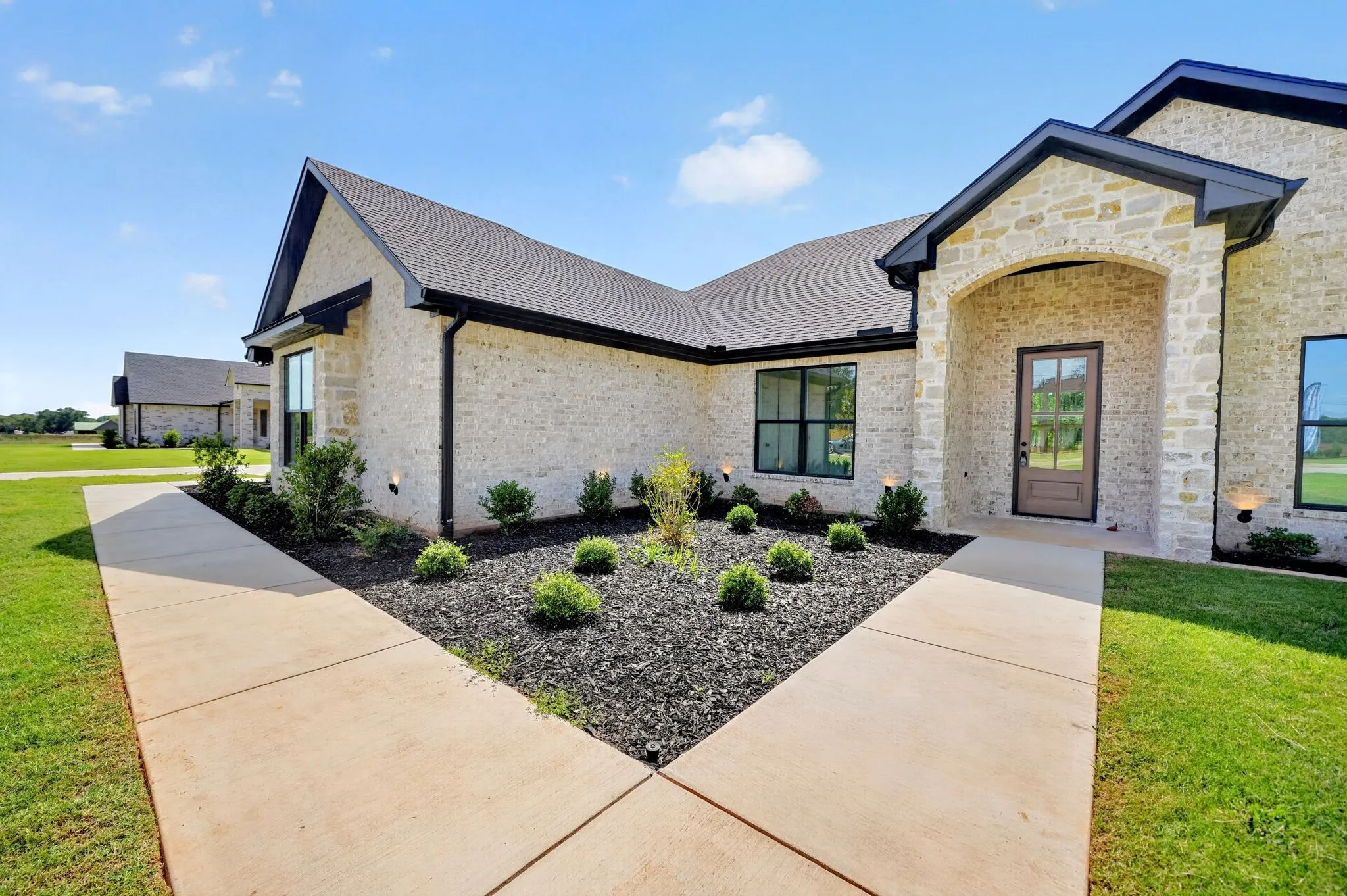 Front entrance of 302 Grace Lane features a landscaped entrance with irrigation installed for easy maintenance.