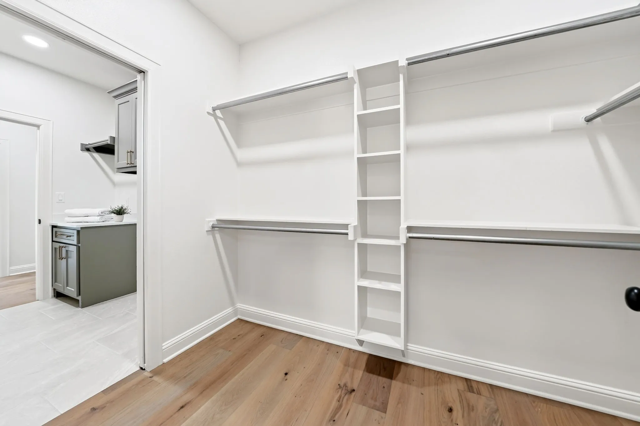 Primary closet connects to the primary bathroom & laundry room.