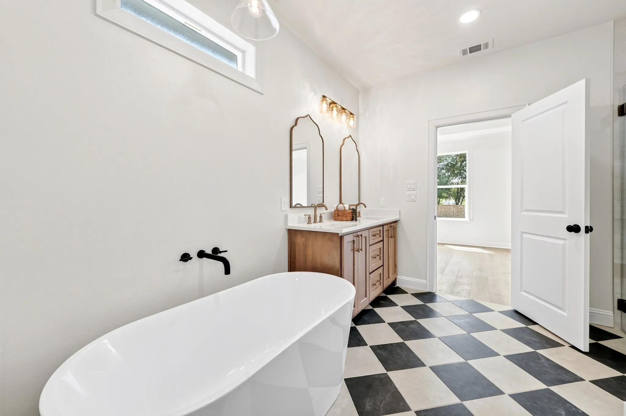 Primary bathroom with views of the primary suite.