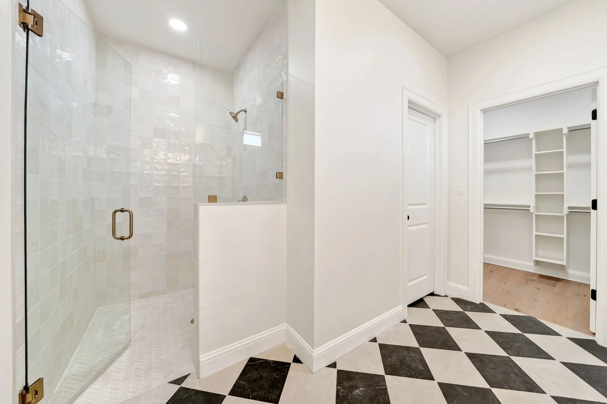 Primary bathroom featuring a stand alone soaking tub, walk-n tiled shower & walk-in closet.