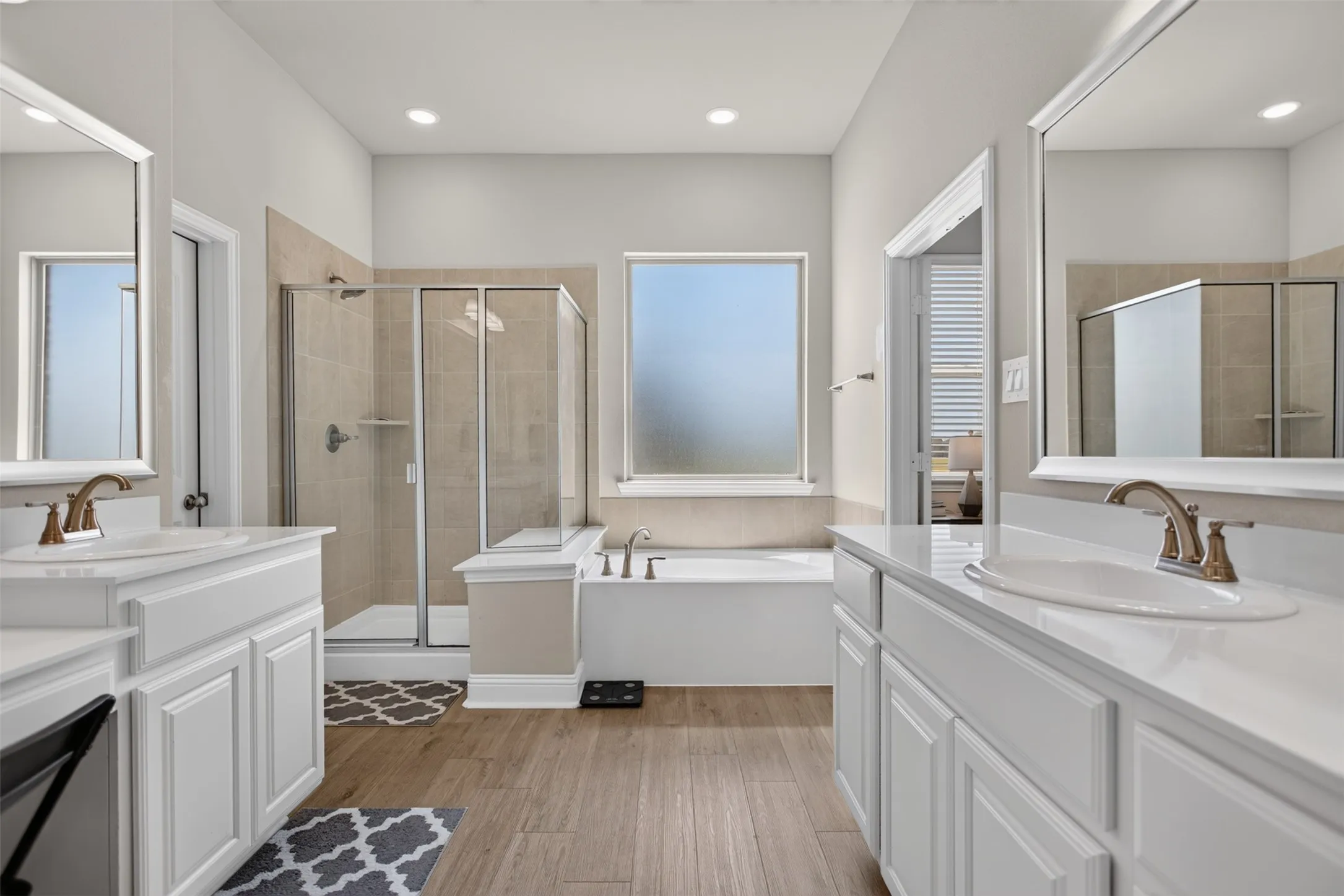 Dual vanities with white cabinetry and undermount sinks