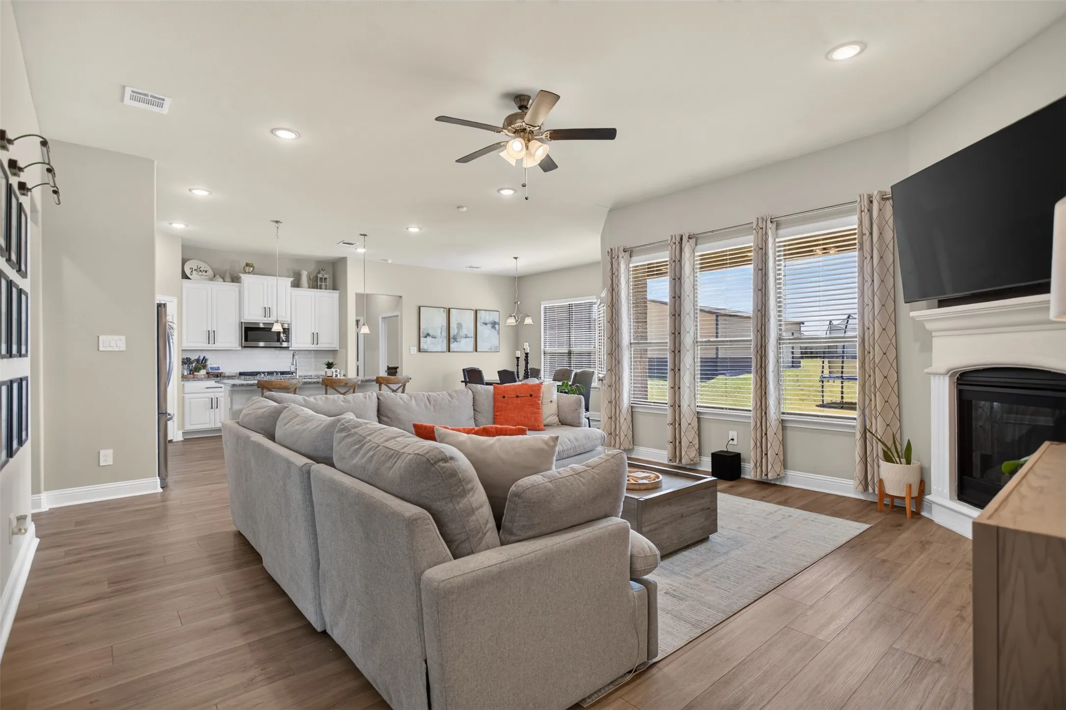 Wood-finish flooring, recessed lighting, and a ceiling fan