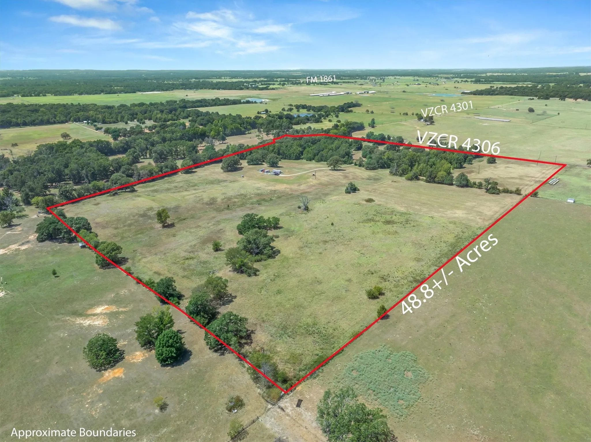 Expansive 48.8+/- acre parcel featuring open fields and mature tree clusters