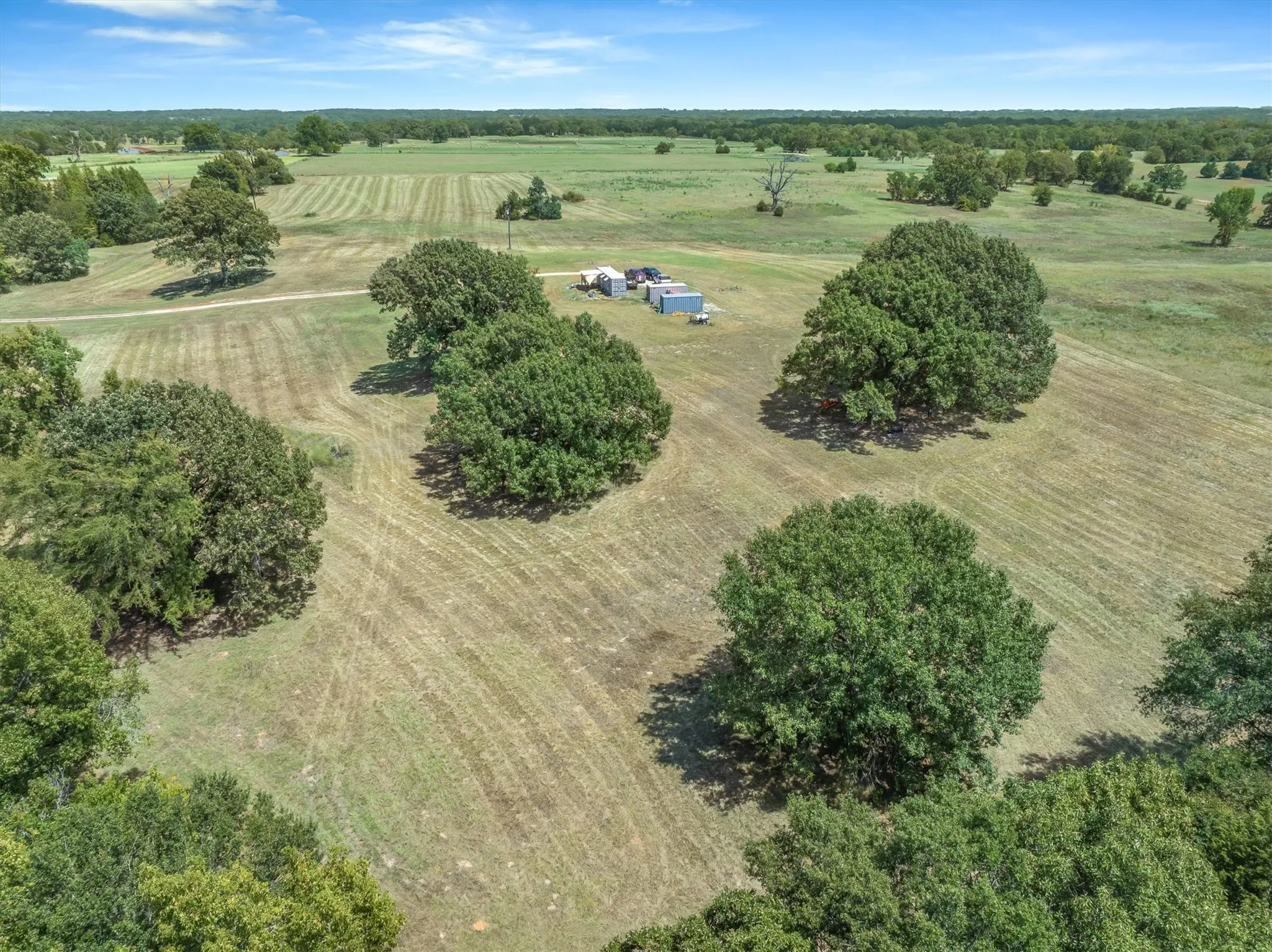 Expansive land featuring mature trees and clearings