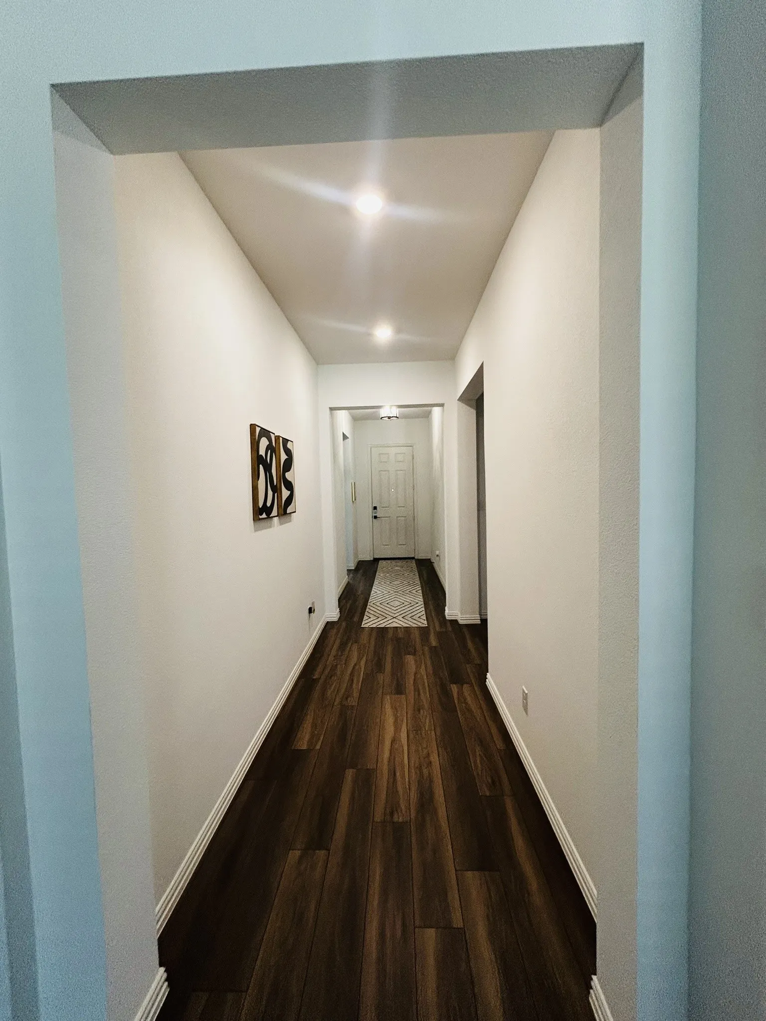 Recessed ceiling light fixture, wall-to-wall carpeting, and a window with blinds