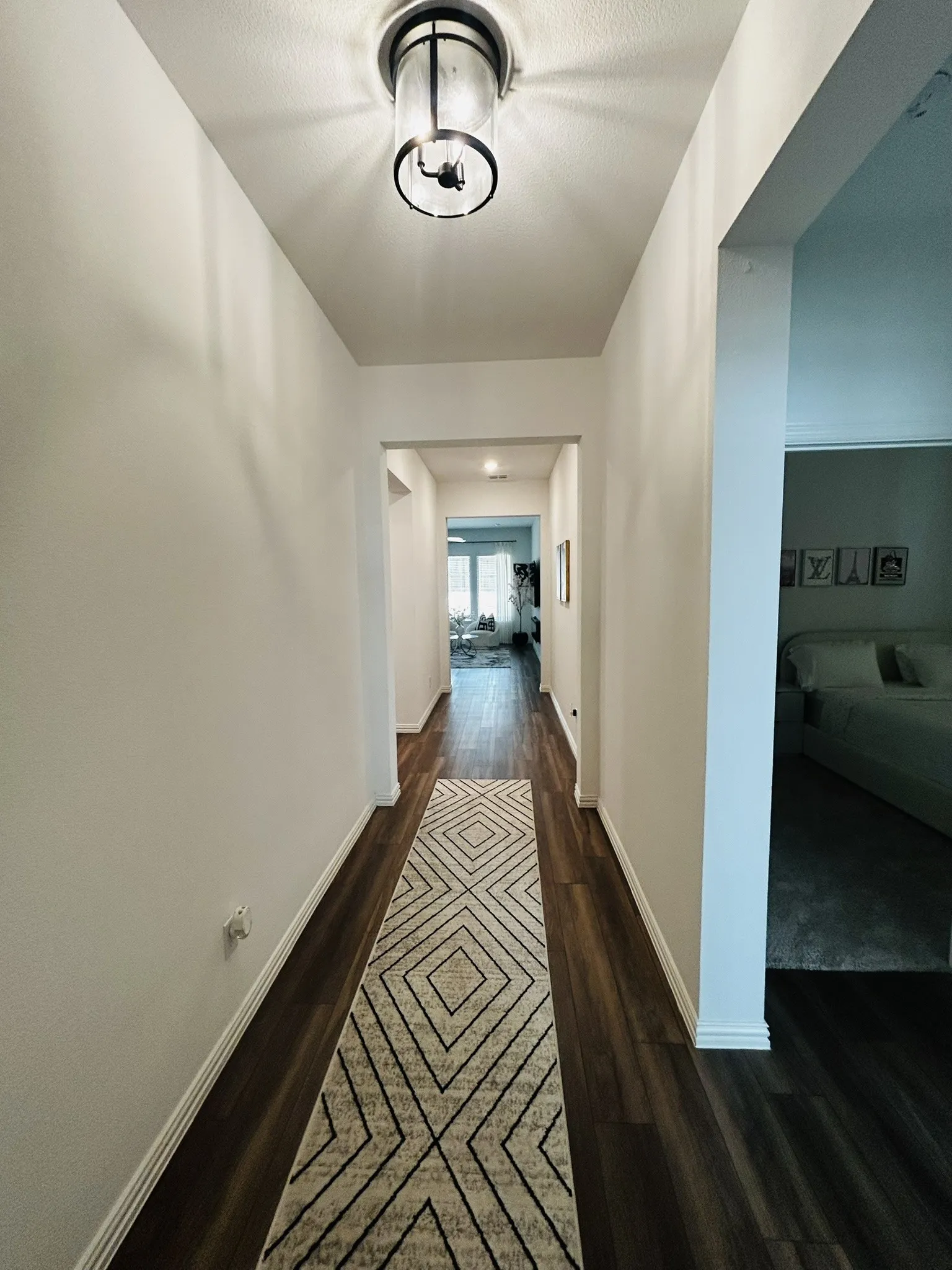 Wood-finish flooring throughout the hallway