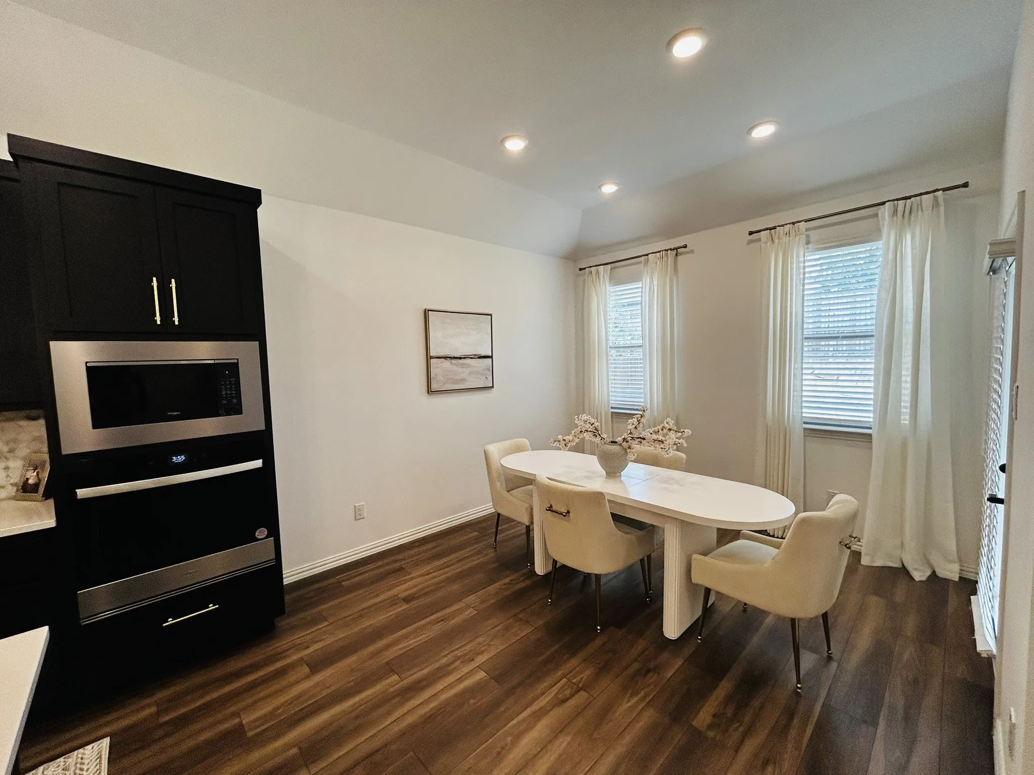 Wood-finish flooring, recessed lighting, and dual windows with blinds