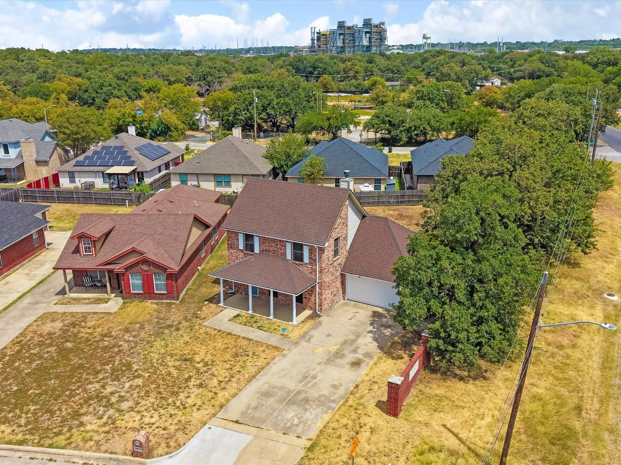 Brick facade residence with covered front porch and attached garage