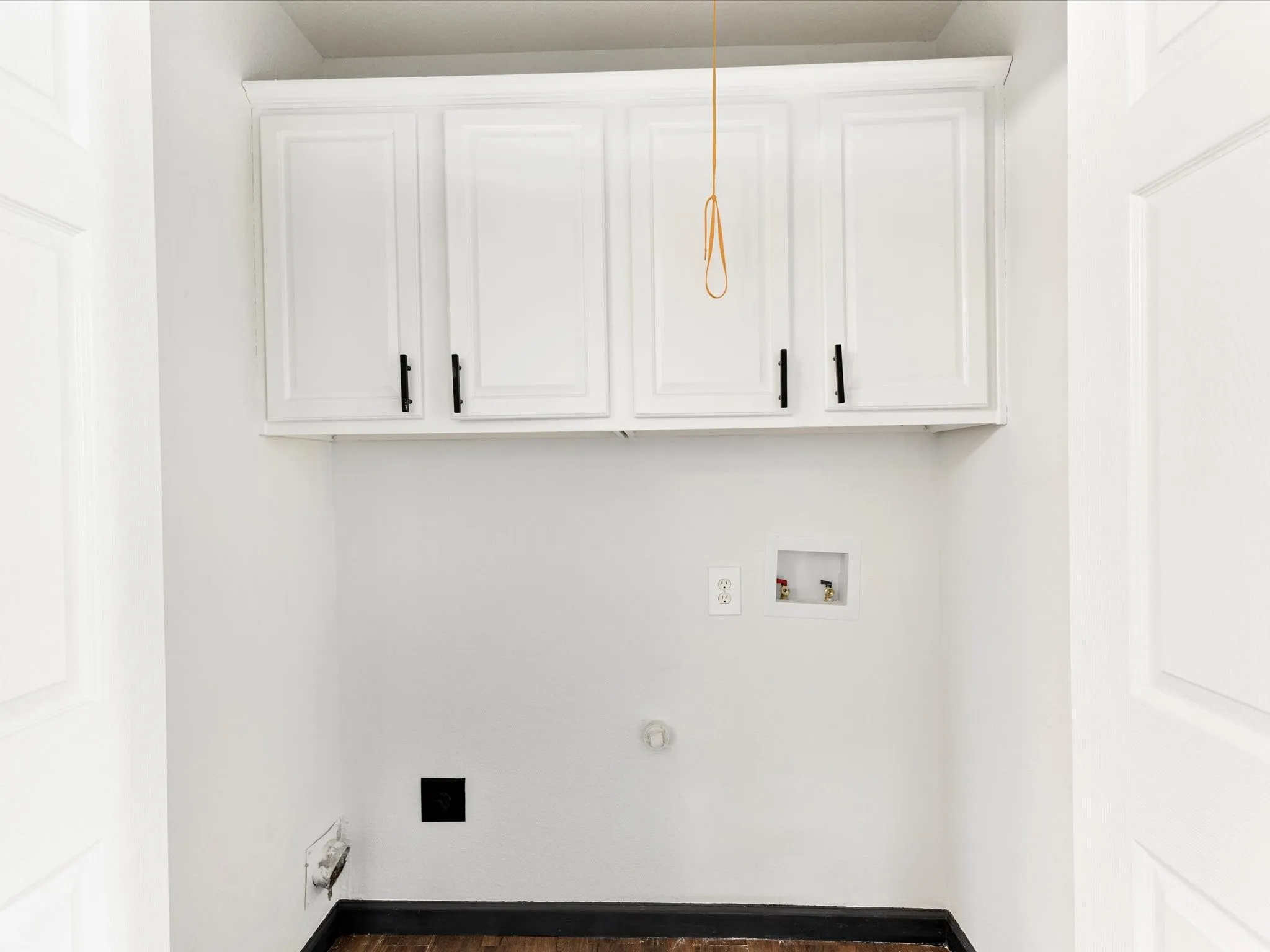 White shaker-style upper cabinetry with matte black hardware