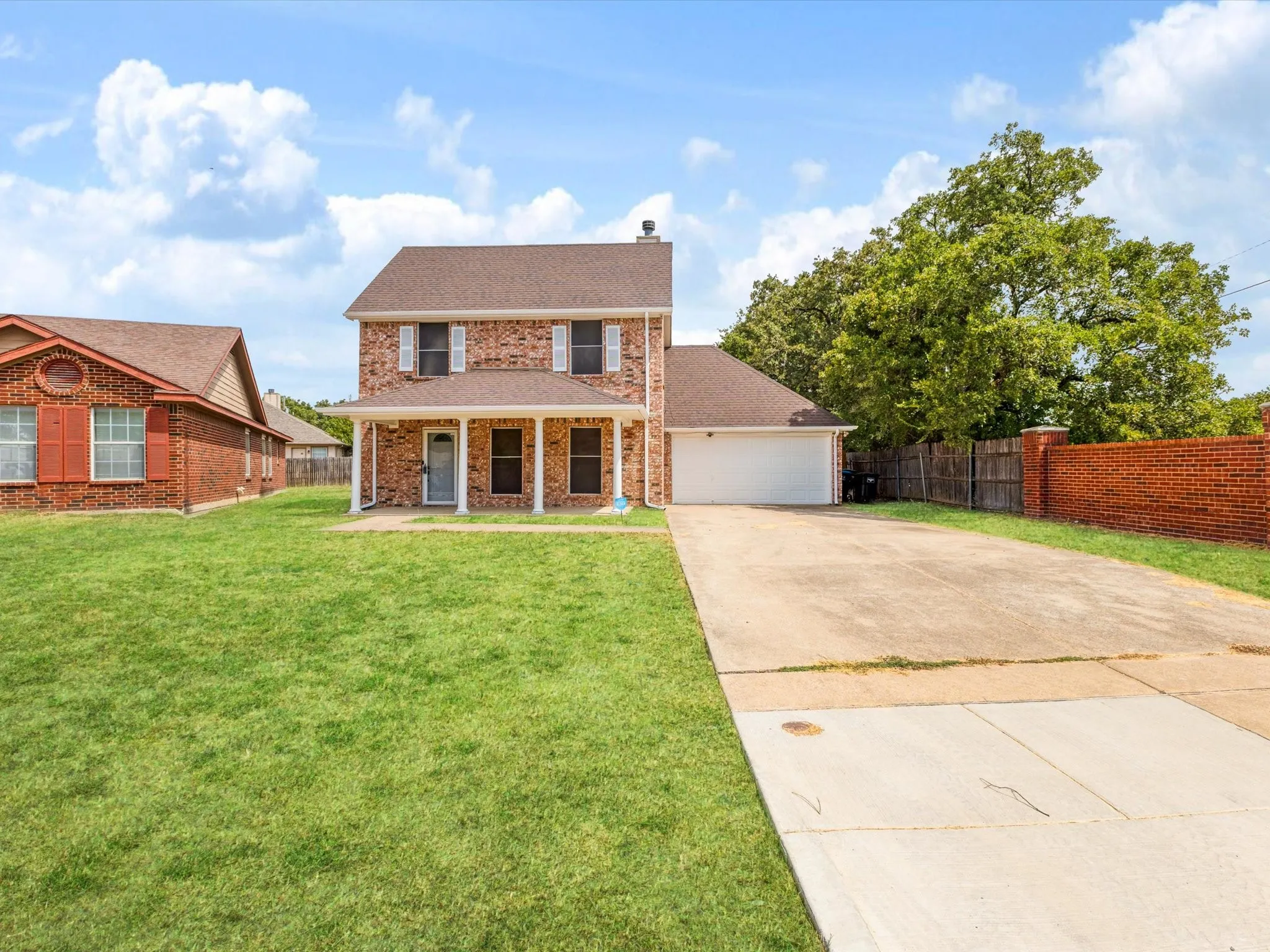 Brick exterior with white shutters and a covered porch