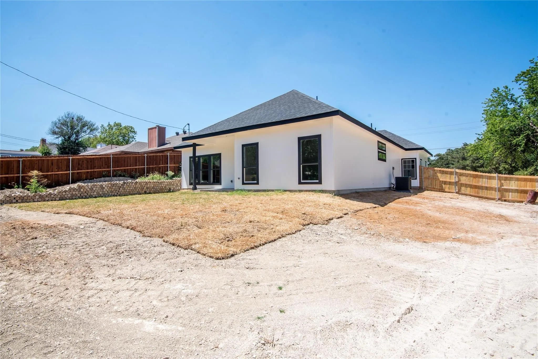 White exterior with contrasting black window frames and trim