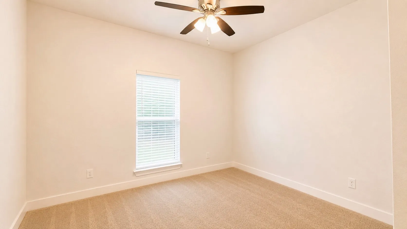 Carpeted flooring, window with blinds, ceiling fan with integrated lighting, and neutral wall tones