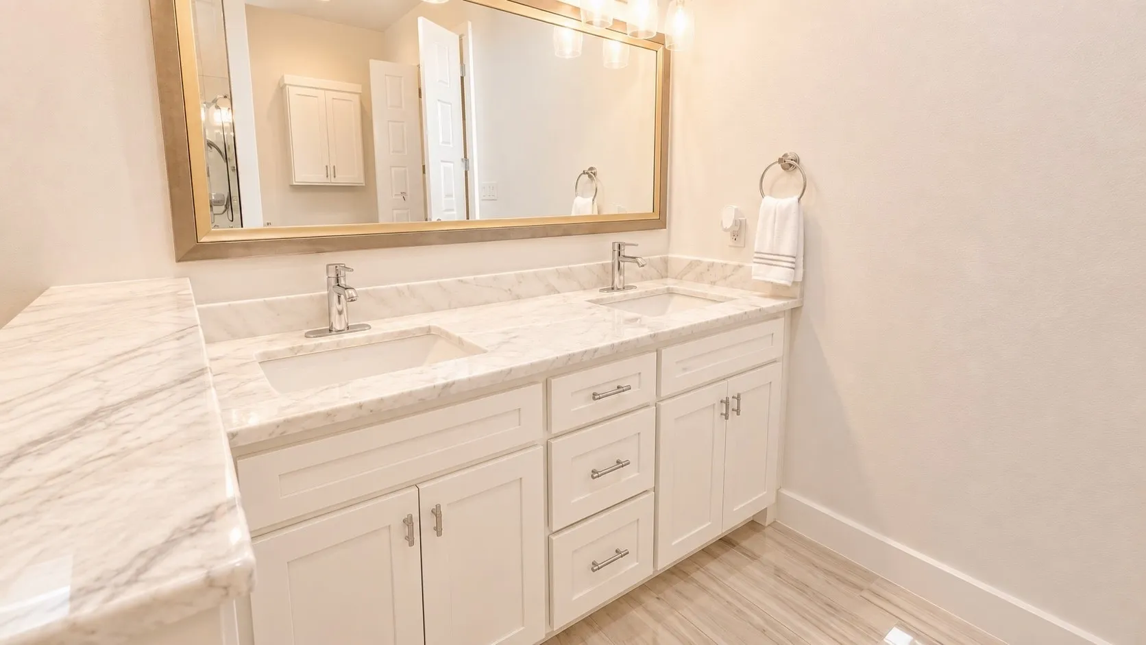 Dual vanity with stone-finish countertops, undermount sinks, and chrome-finish fixtures