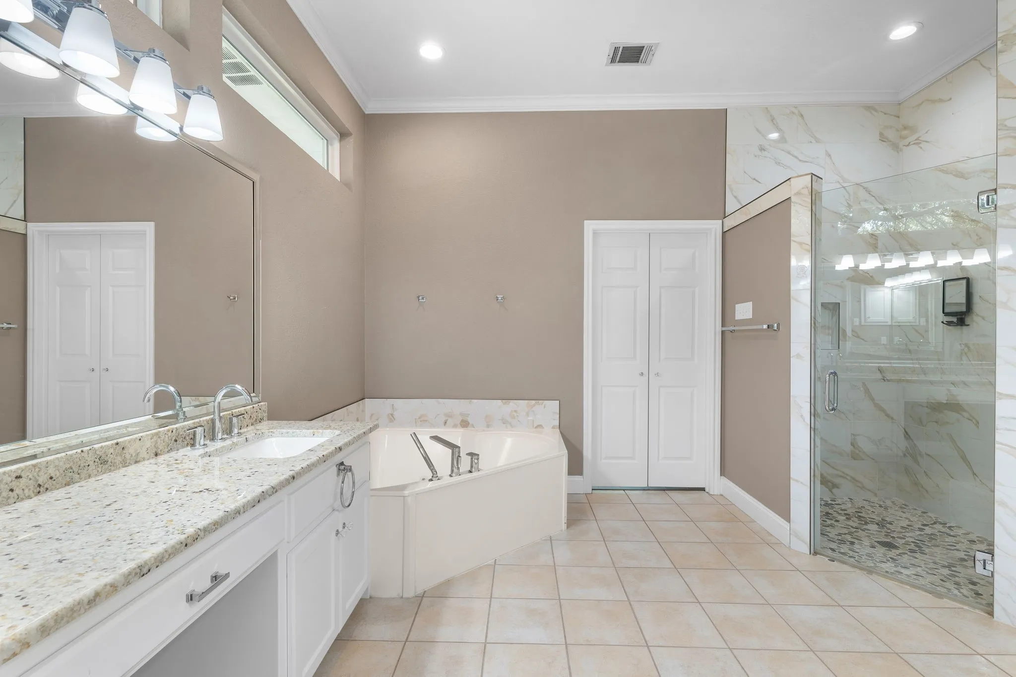 Dual vanity with integrated sinks, granite countertop, and chrome fixtures