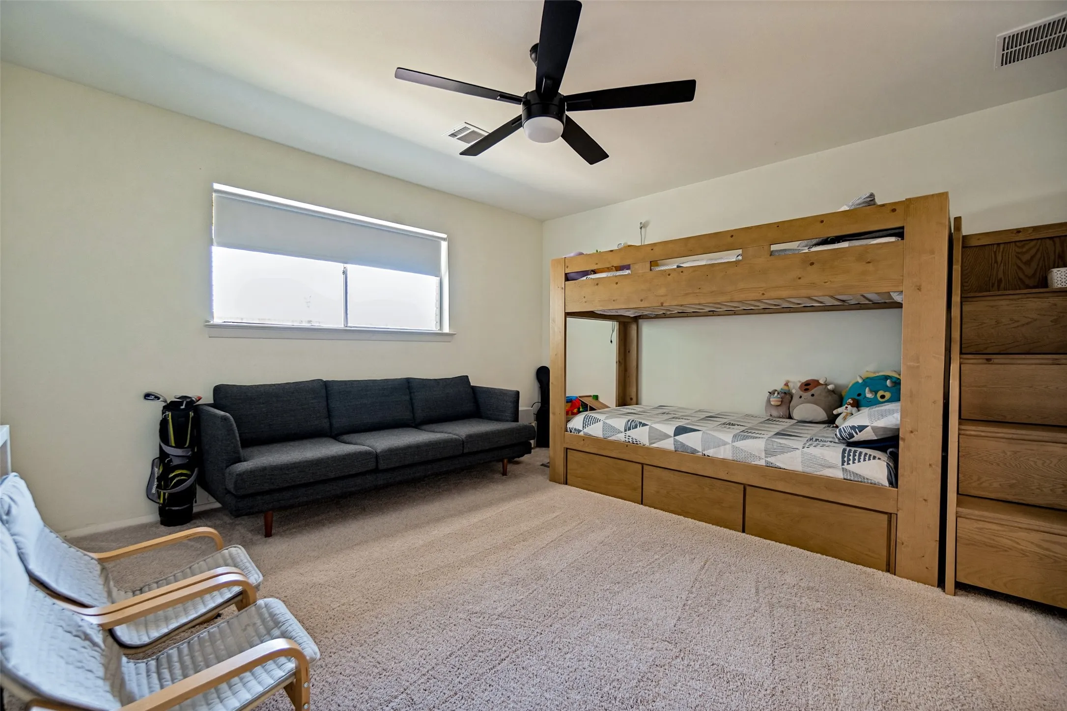 Recessed window with roller shade, neutral wall color, and a ceiling fan with integrated lighting