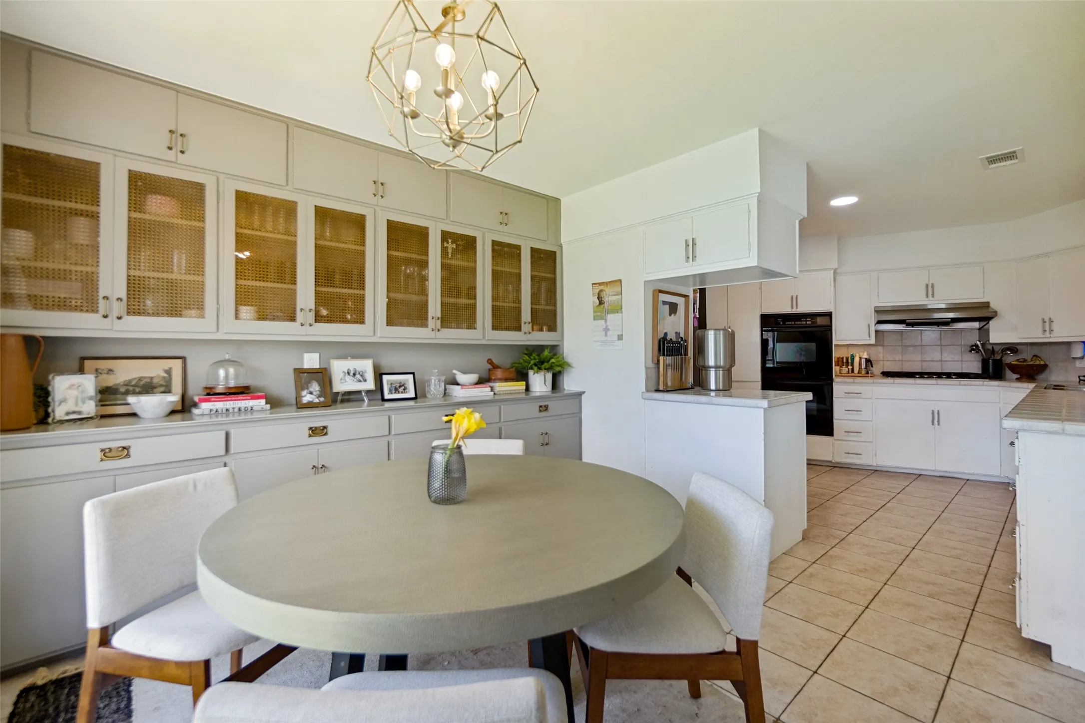 Kitchen featuring light-toned cabinetry, a built-in oven, and a gas cooktop