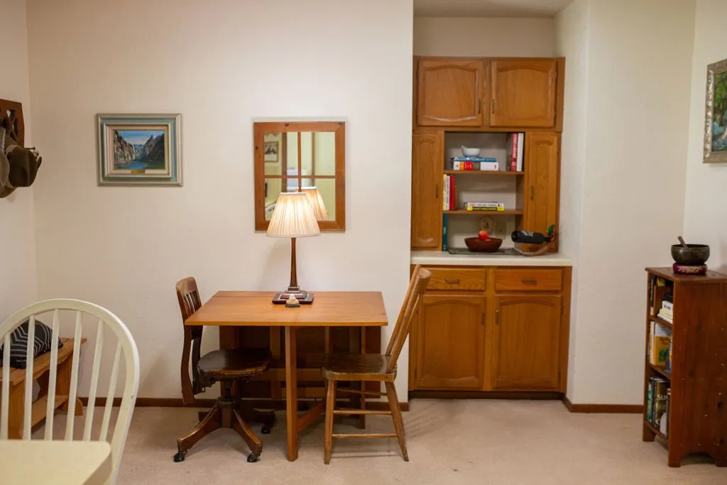 Built-in cabinetry with wood-finish doors, open shelving, and a light-toned countertop