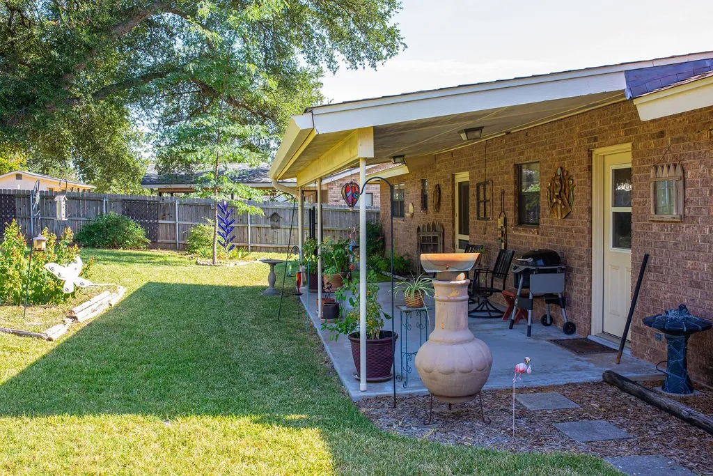 Covered patio with a brick exterior, direct exterior door access, and a concrete surface
