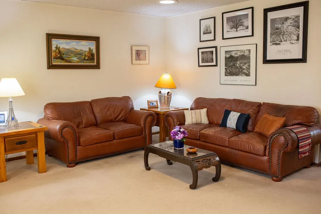 Neutral wall paint, recessed ceiling lighting, wall-mounted artwork, and carpeted flooring