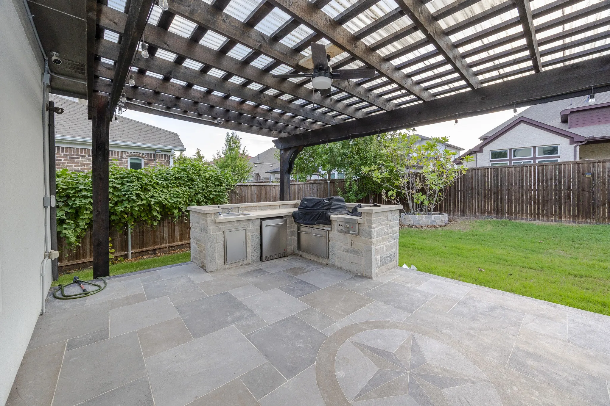 Expansive patio featuring large format tile flooring with an inlaid star​​‌​​​​‌​​‌‌​‌‌​​​‌‌​‌​‌​‌​​​‌​​ design