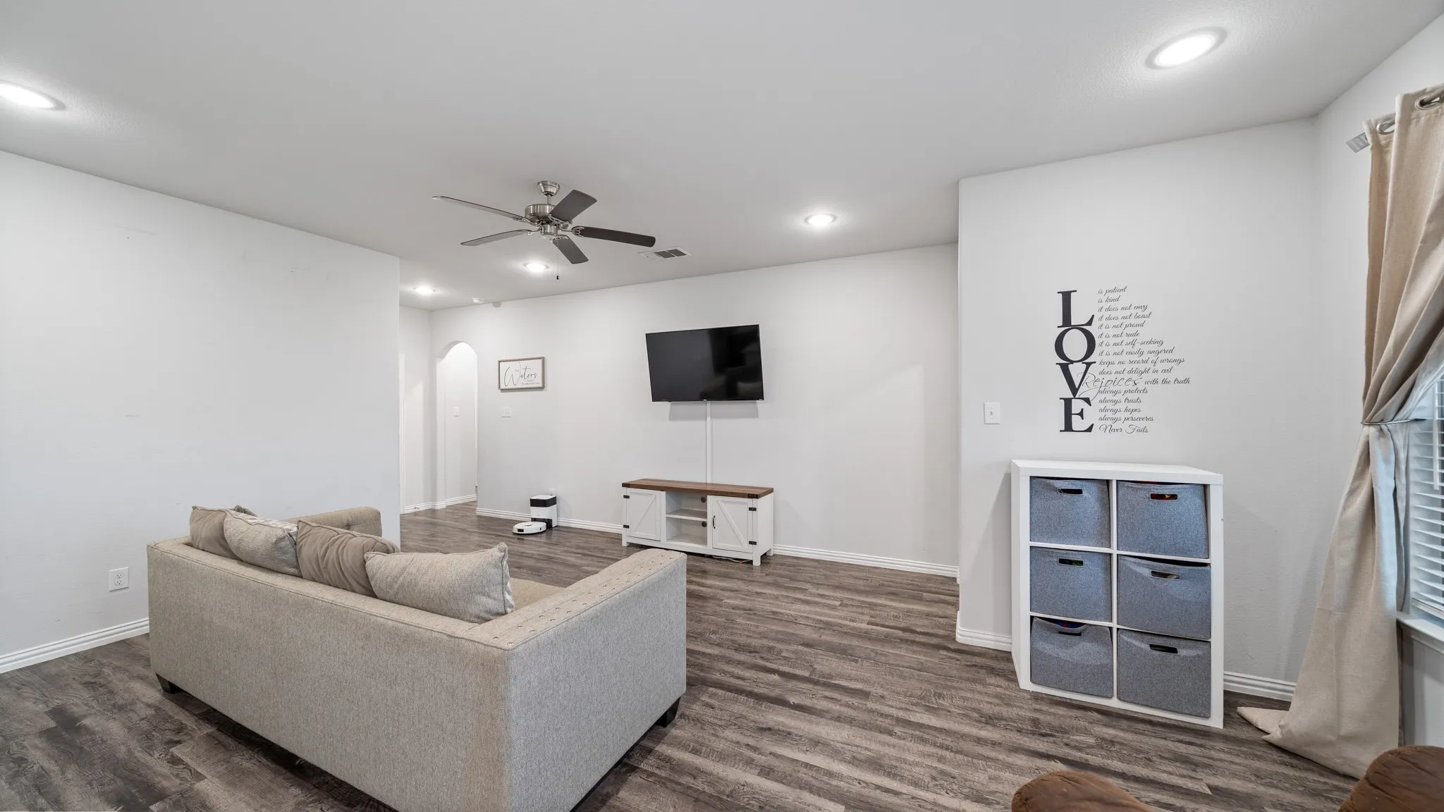Wood-finish flooring, recessed lighting, ceiling fan, window with blinds