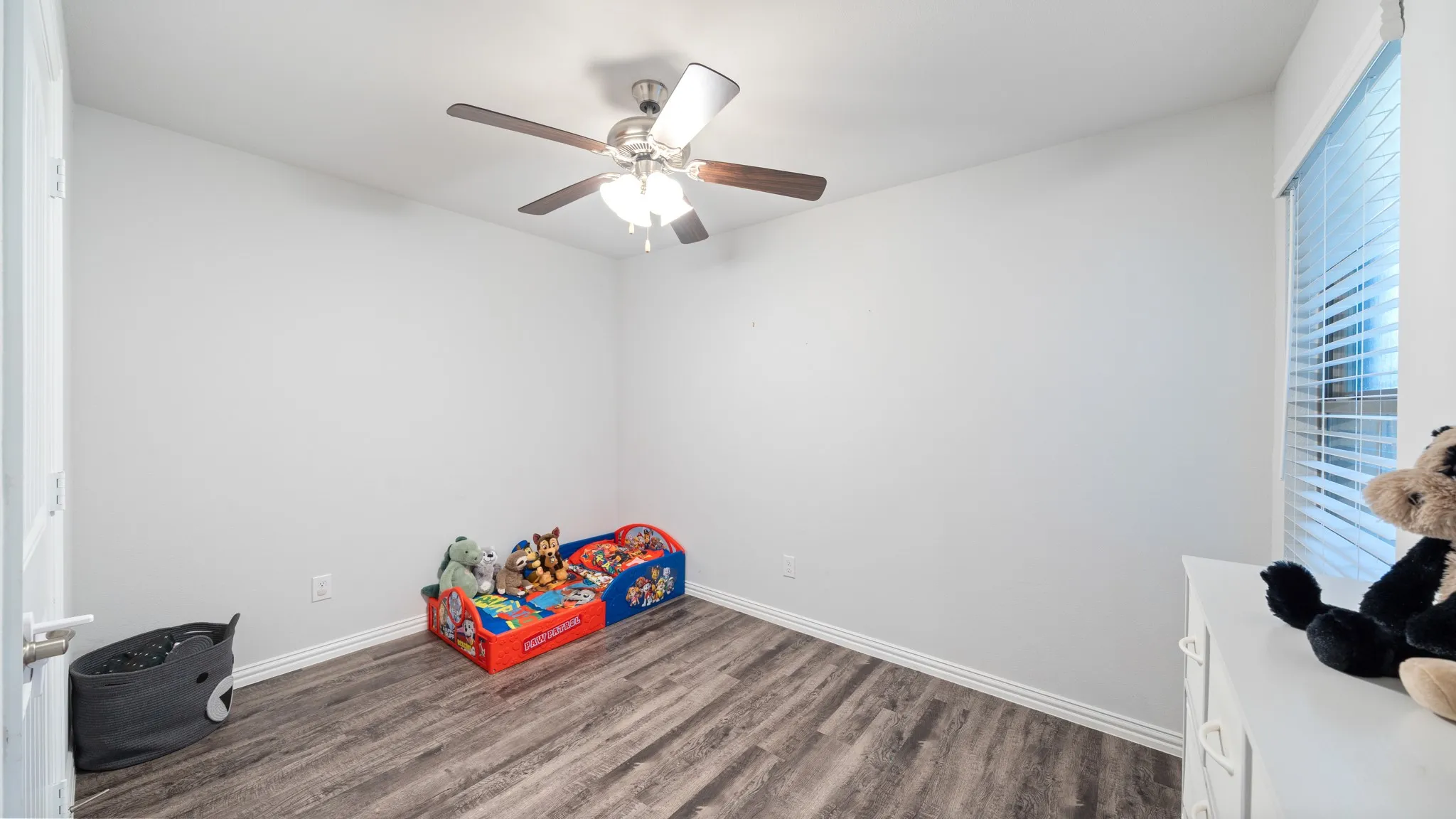 Wood-finish flooring with white baseboards