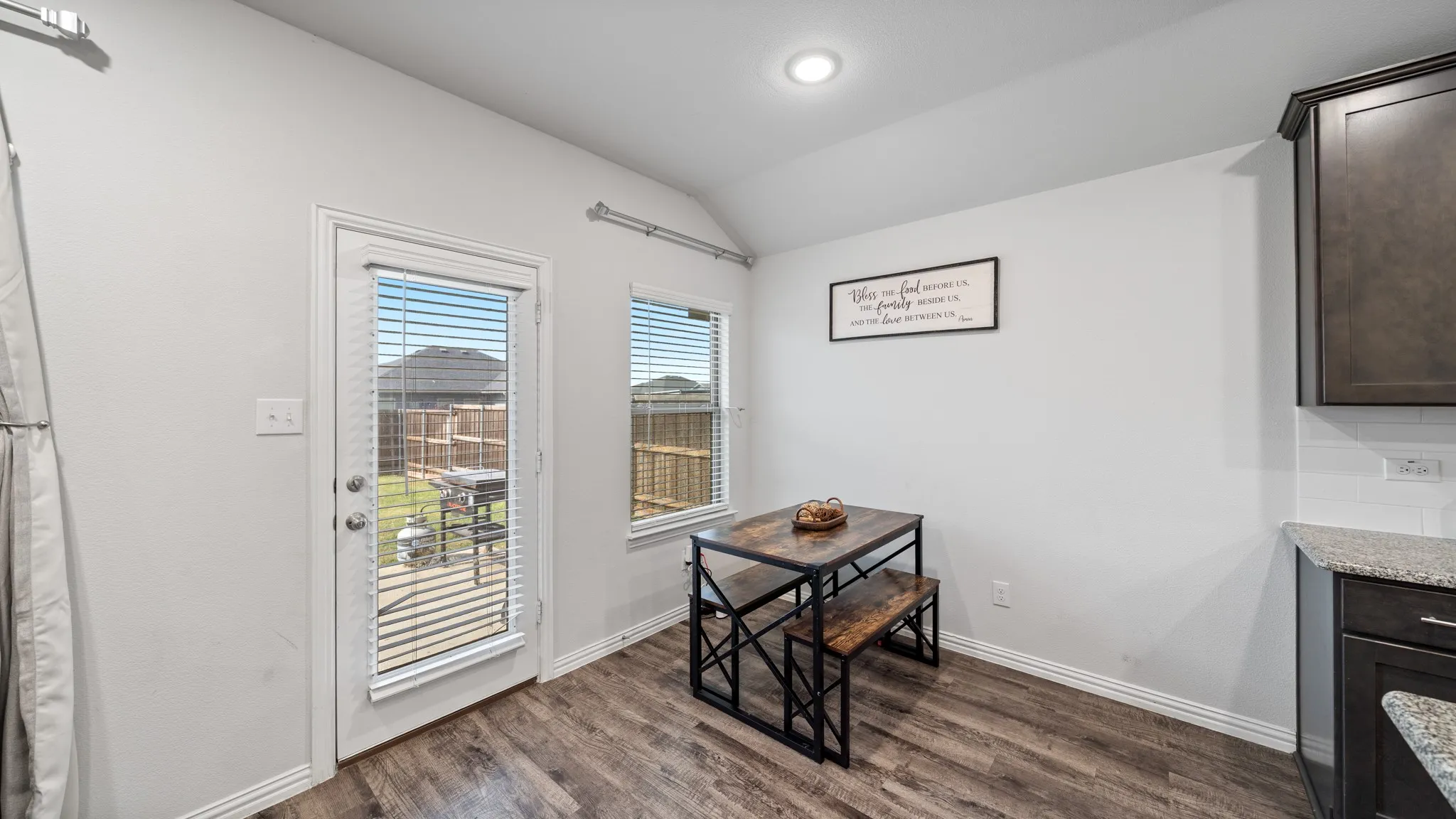 Wood-finish flooring, recessed lighting, and a white tile​​‌​​​​‌​​‌‌​‌‌​​​‌‌​‌​‌​‌​​​‌​​ backsplash