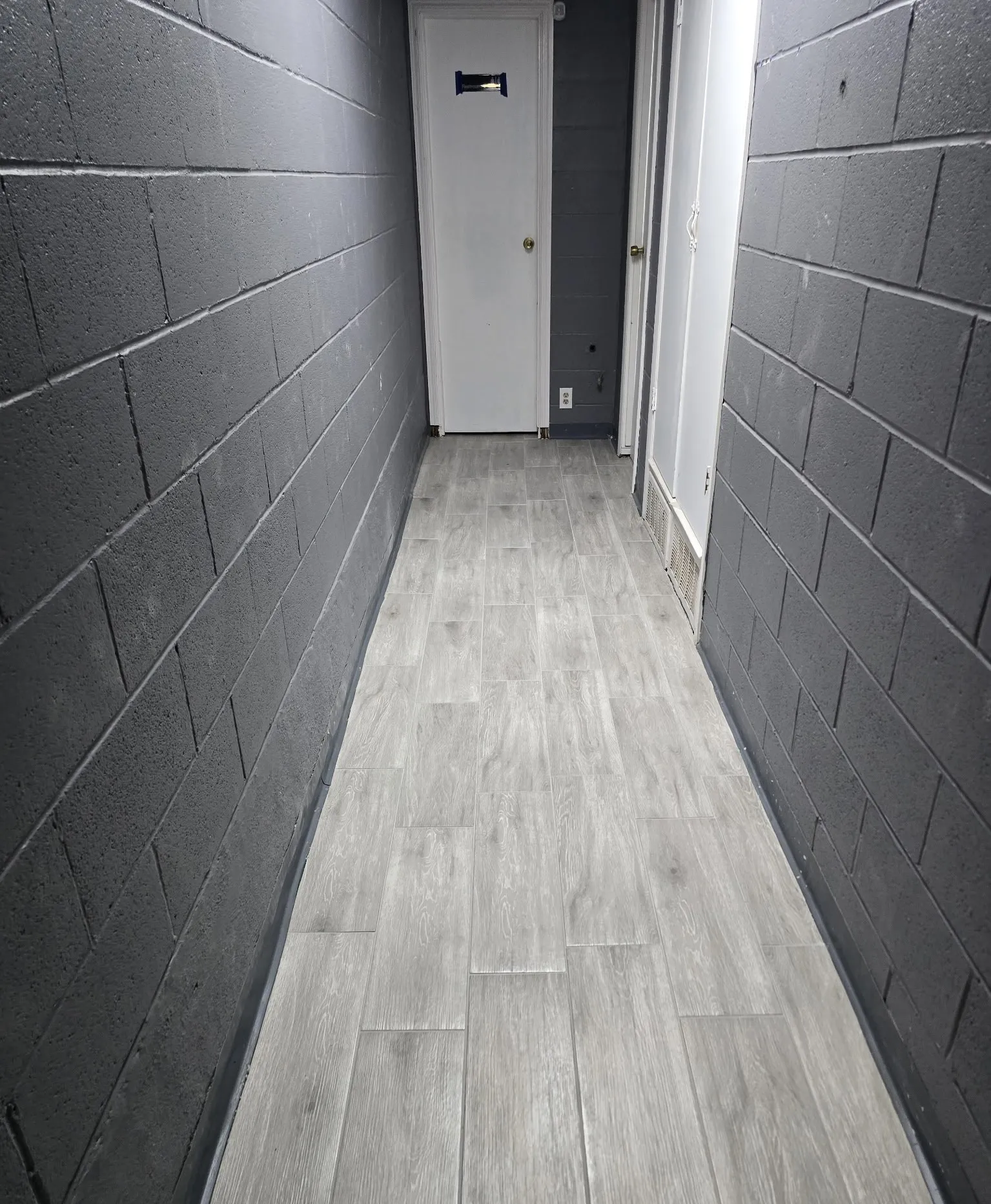 Wood-finish flooring with a block wall texture