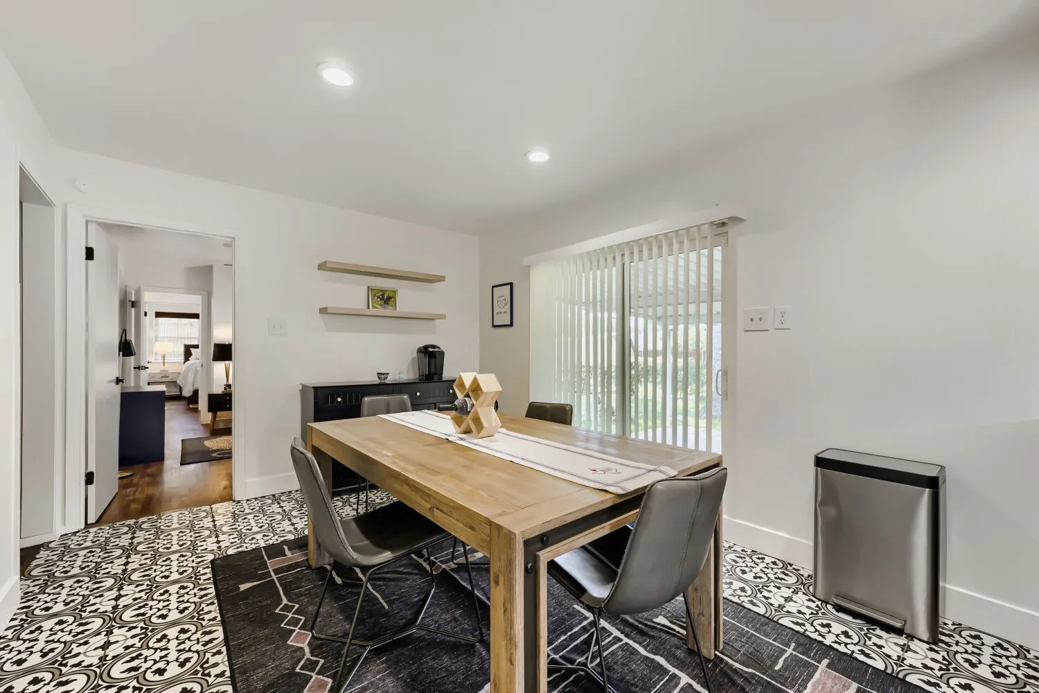 Stainless steel range, wood-finish range hood, white subway tile backsplash, dark-finish cabinetry, and light-finish countertops