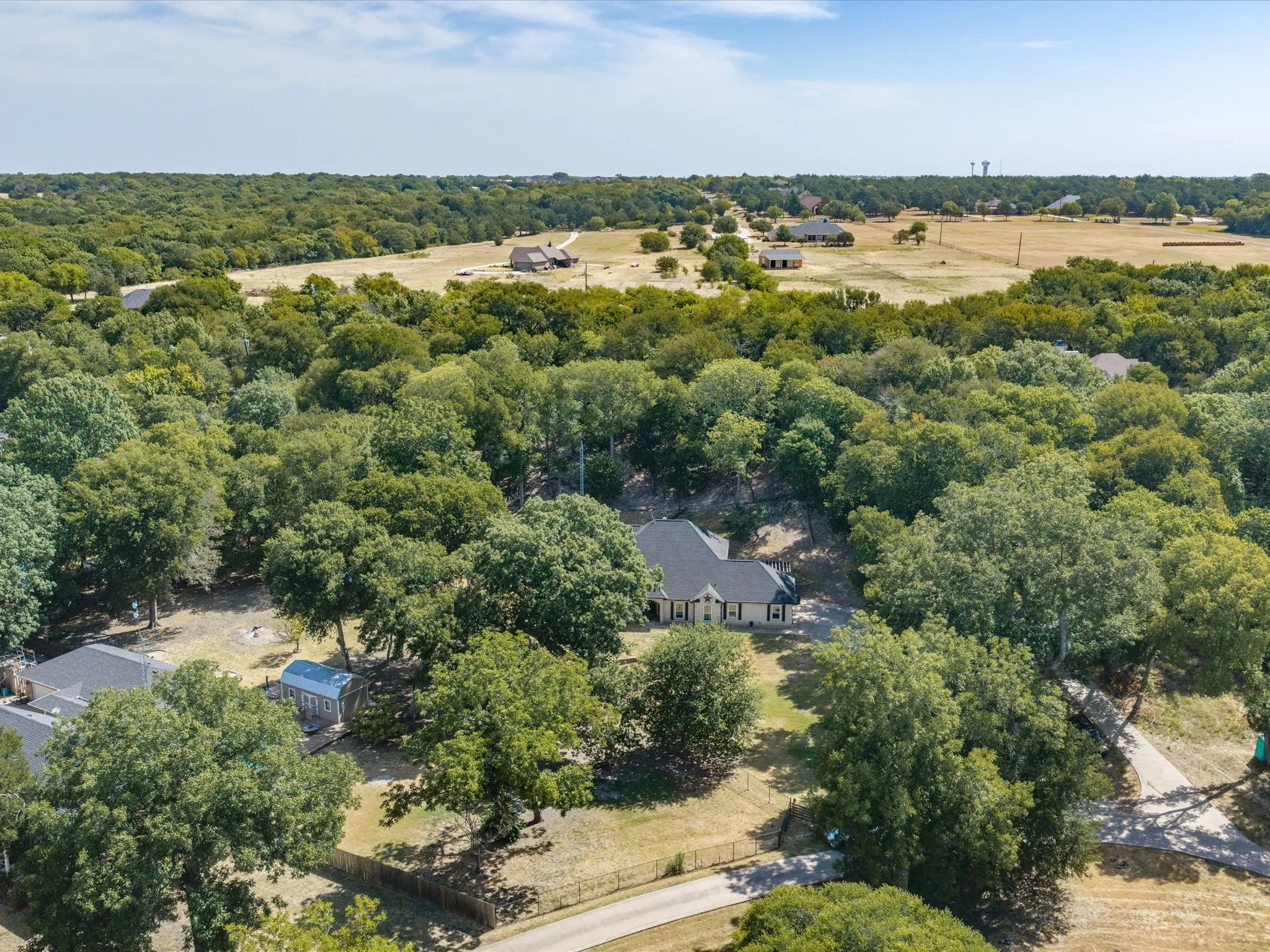 Aerial perspective showcasing a property nestled within abundant mature trees