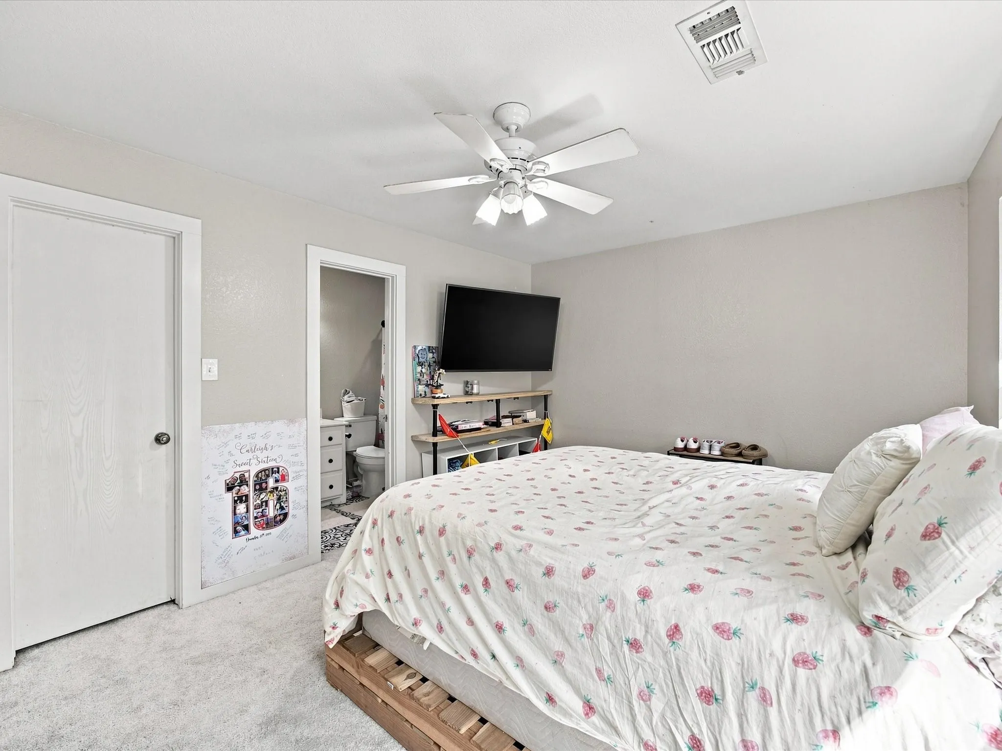 Plush carpet flooring and a ceiling fan with integrated lighting