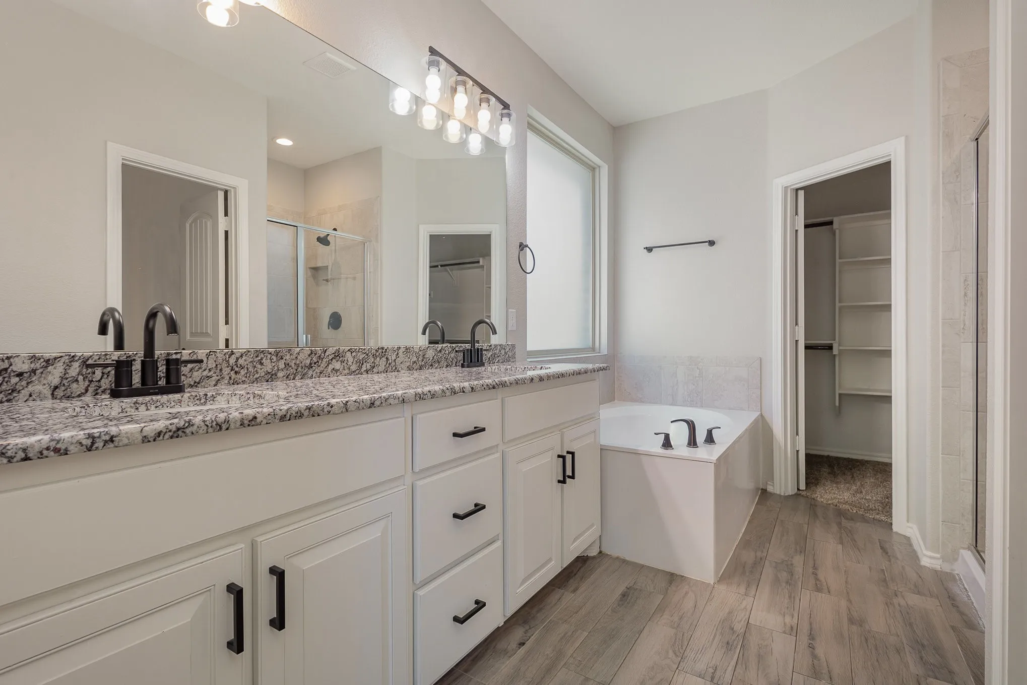Features granite countertops, dual sink, separate shower from garden tub, walk-in closet