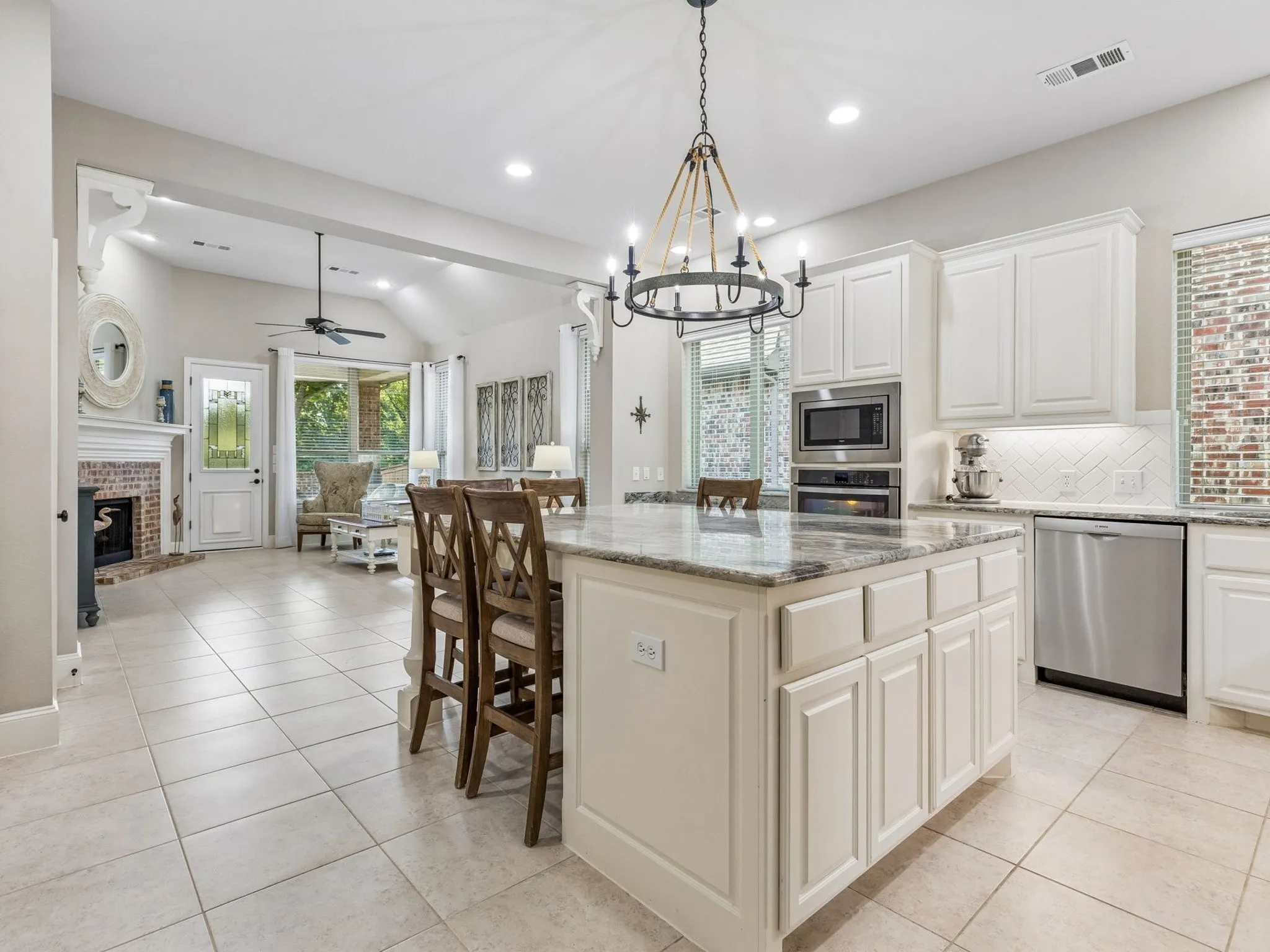 A look back into this Great room and Open space, white cabinetry,lots of storage and stainless steel appliances.