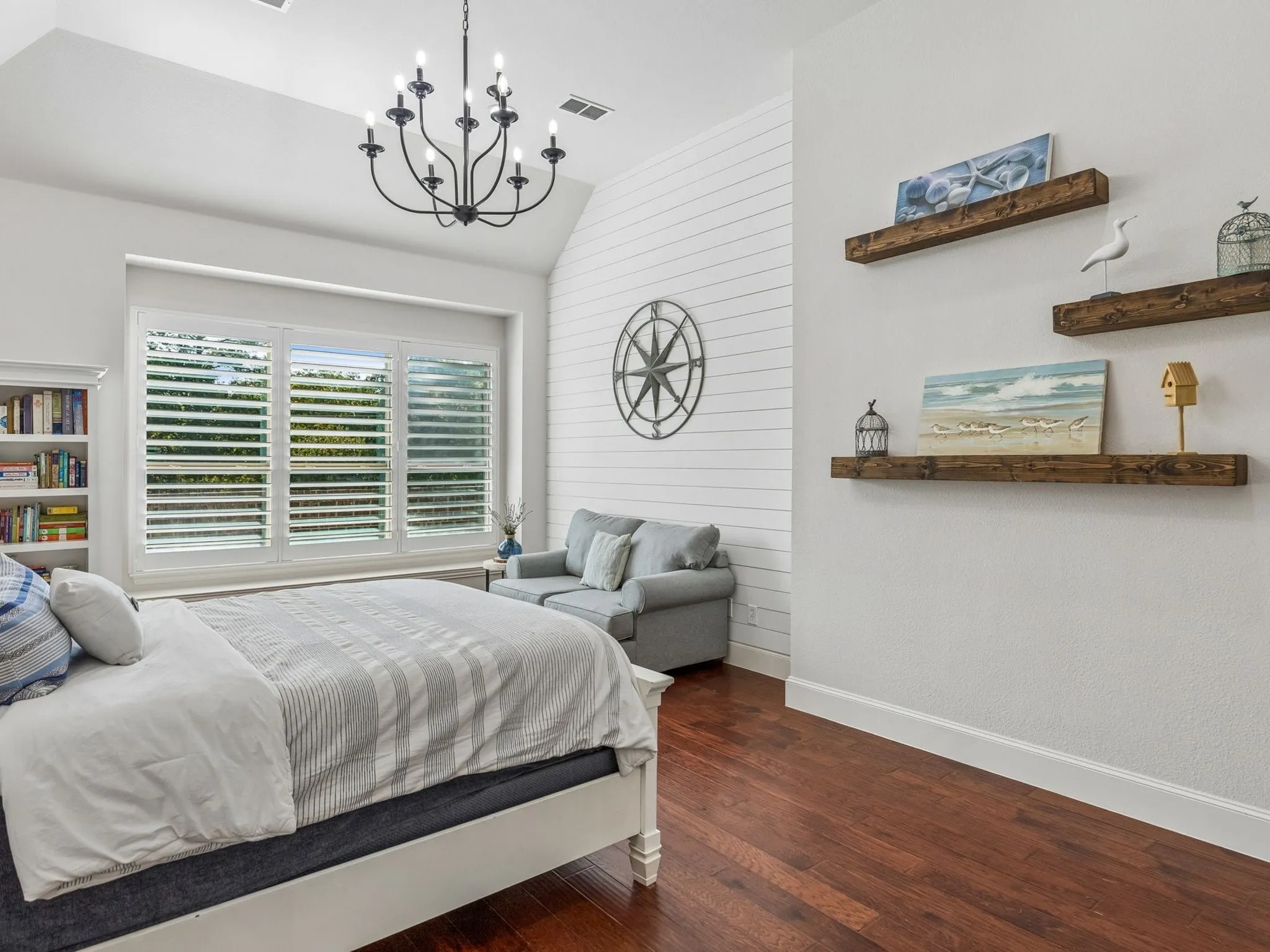 Vaulted ceiling, seating area, and white plantation shutters.