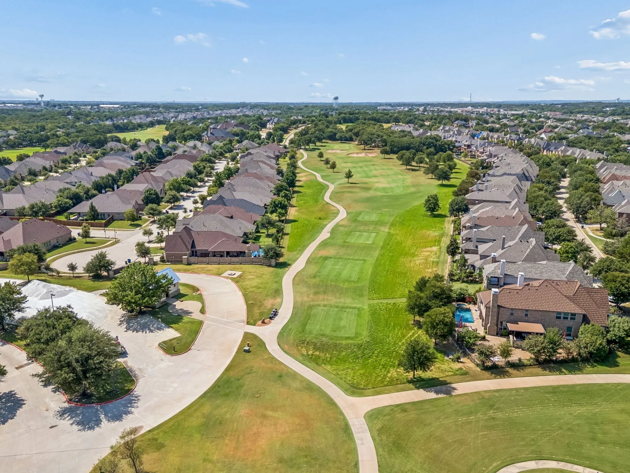 Expansive golf course setting featuring manicured fairways and greens.
