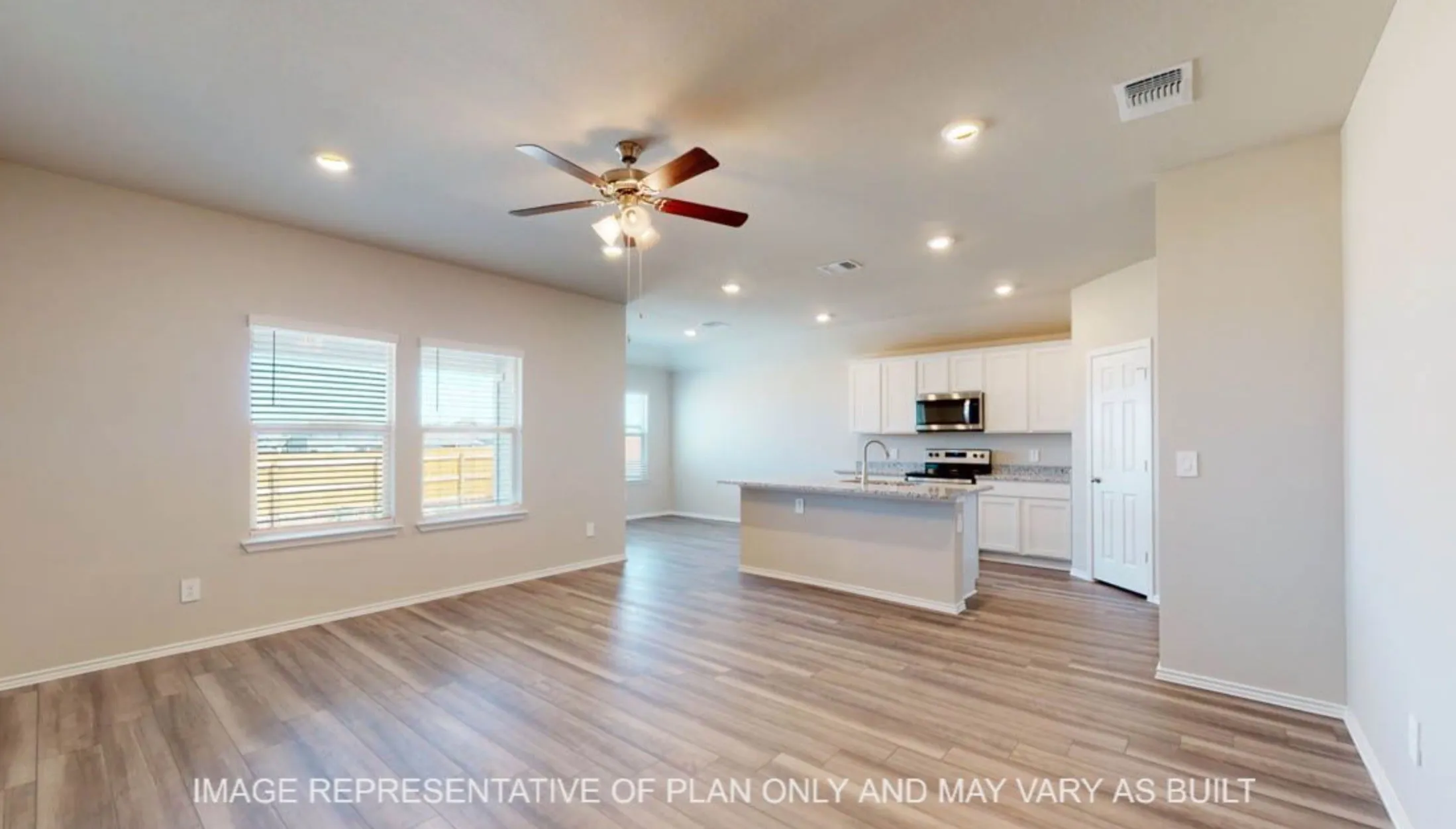 Open-concept interior featuring wood-finish flooring, recessed lighting, and a ceiling fan