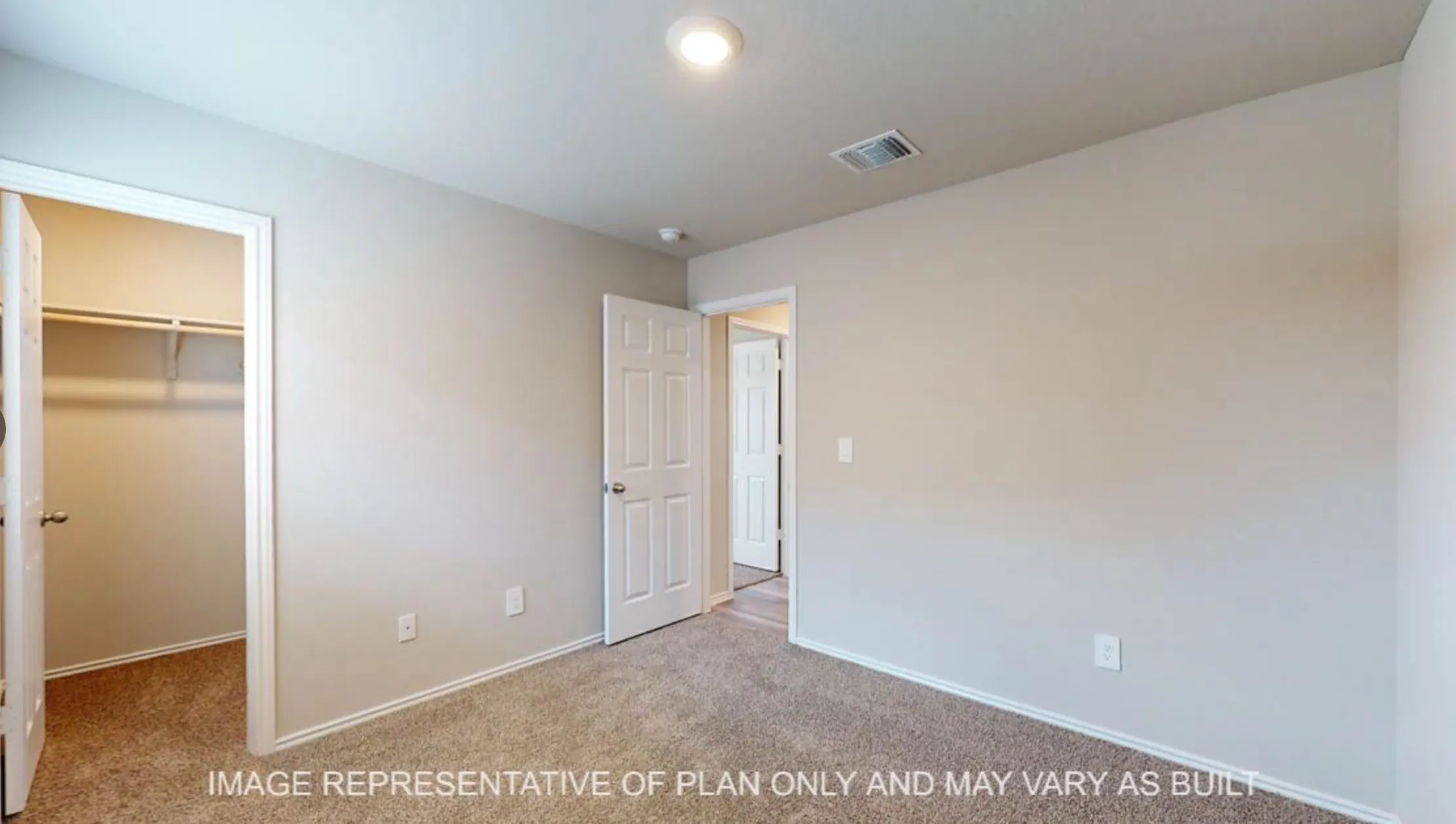 Carpeted flooring, neutral wall tones, recessed lighting, and a built-in closet with shelving