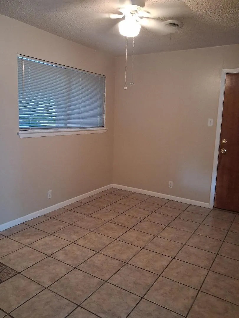 ADJACENT TO KITCHEN WITH A DOOR TO THE DOUBE CAR GARAGE
