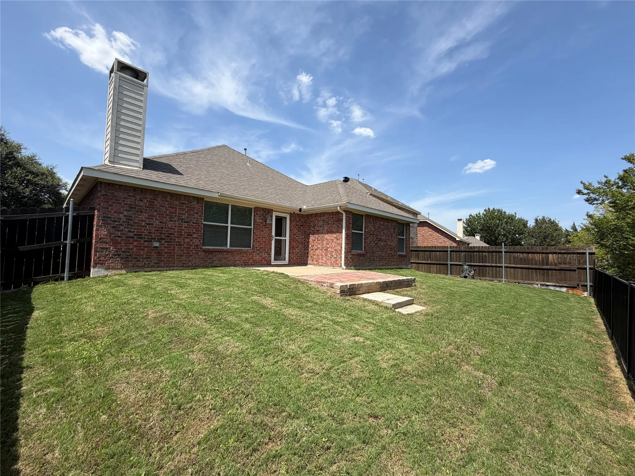 Brick exterior with a gabled roof and a prominent chimney