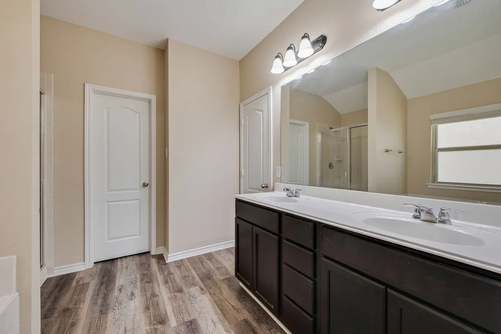 Dual vanity with undermount sinks and dark wood cabinetry