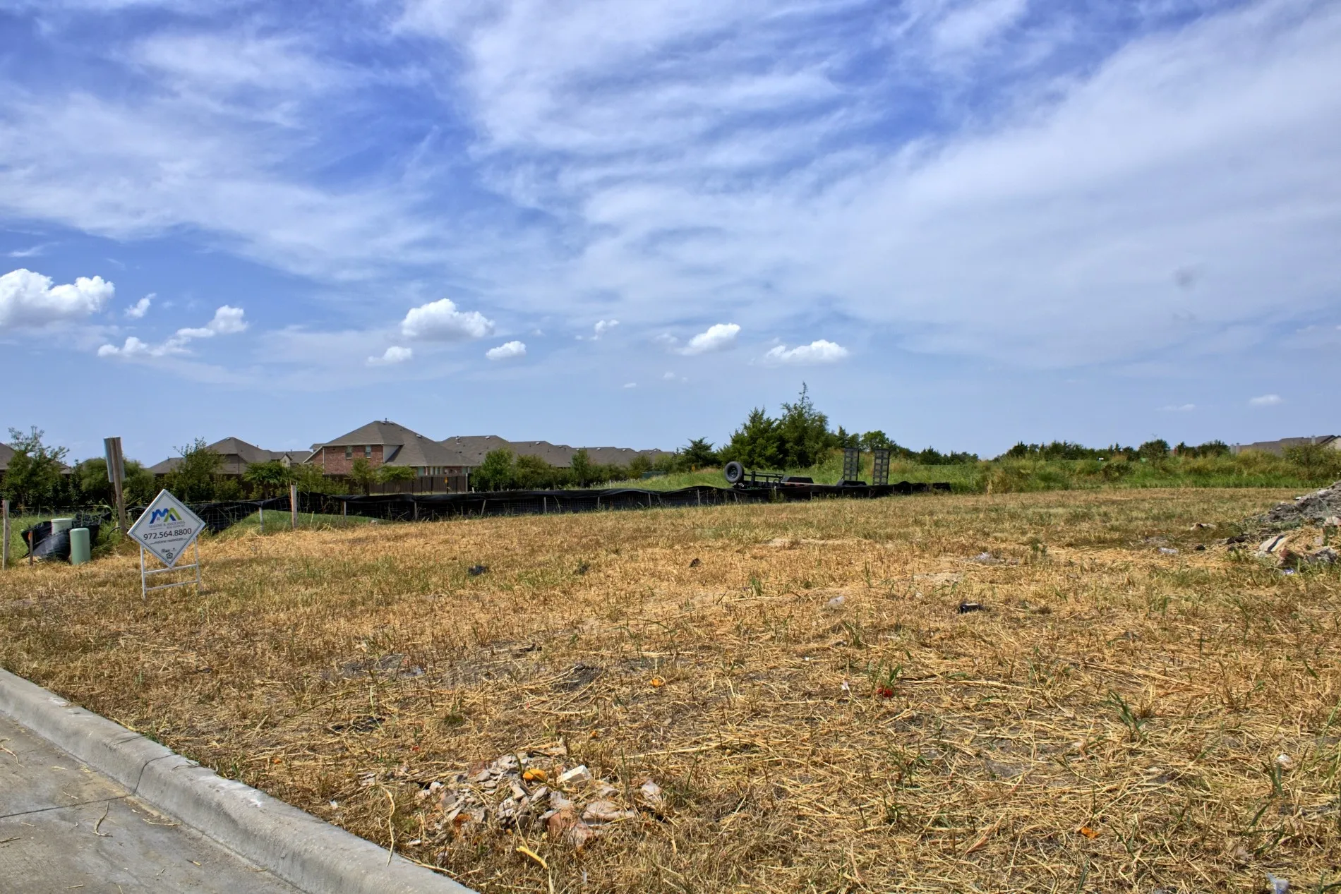 Open lot with visible curb and street