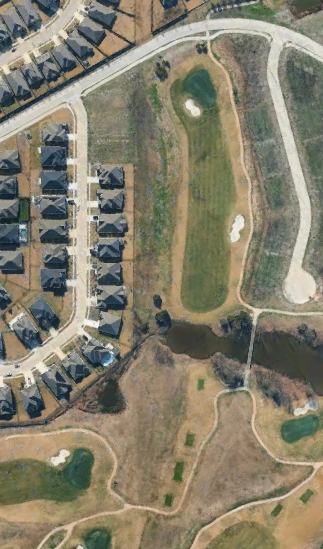 Aerial Photograph. Depicting a residential area with housing units and a golf course
