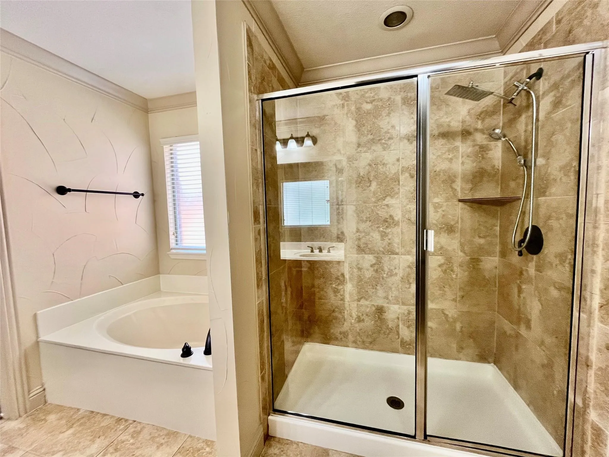 Glass-enclosed shower with tiled walls and flooring