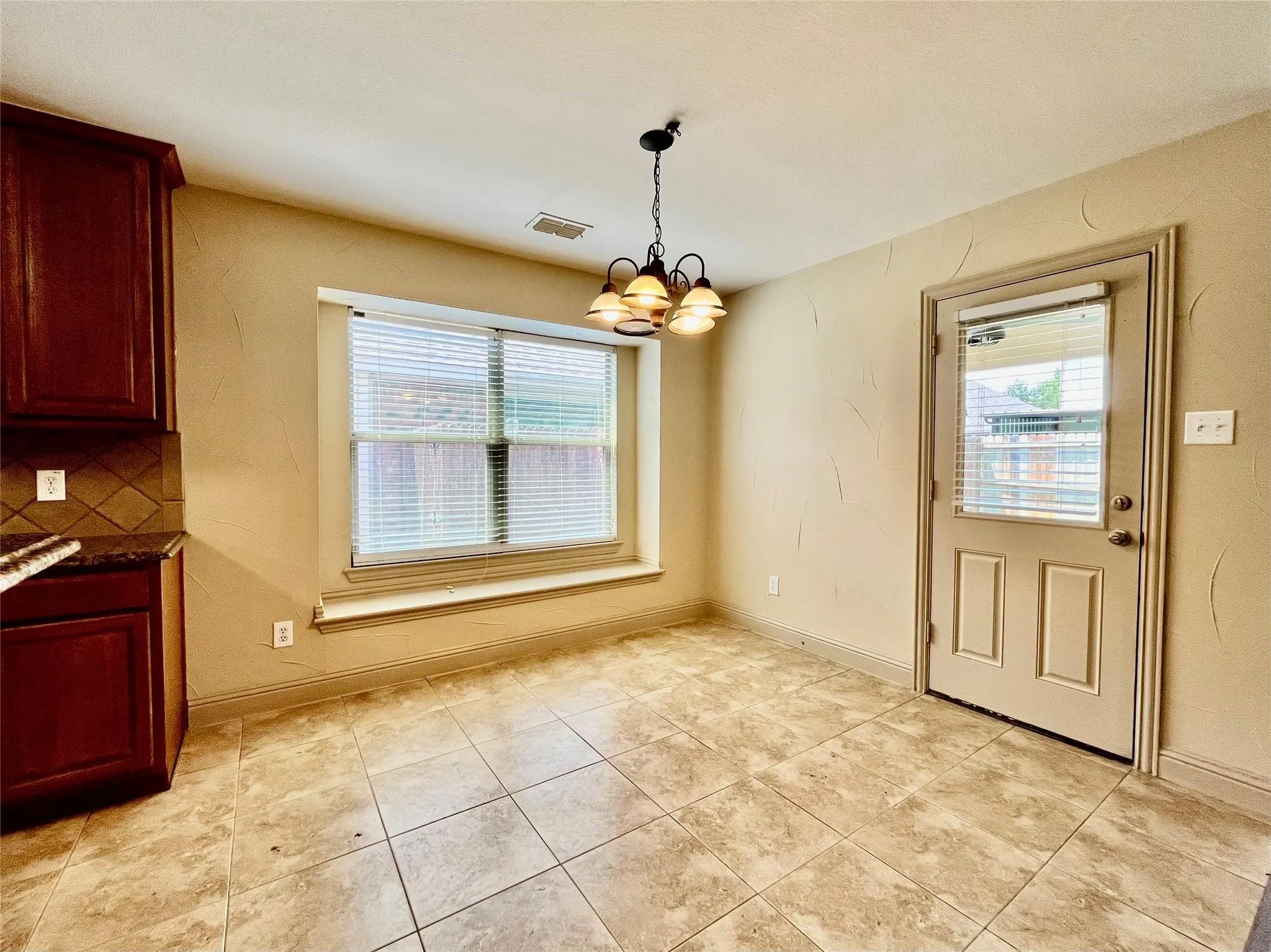Dining area with wood flooring, ceiling fan, and windows